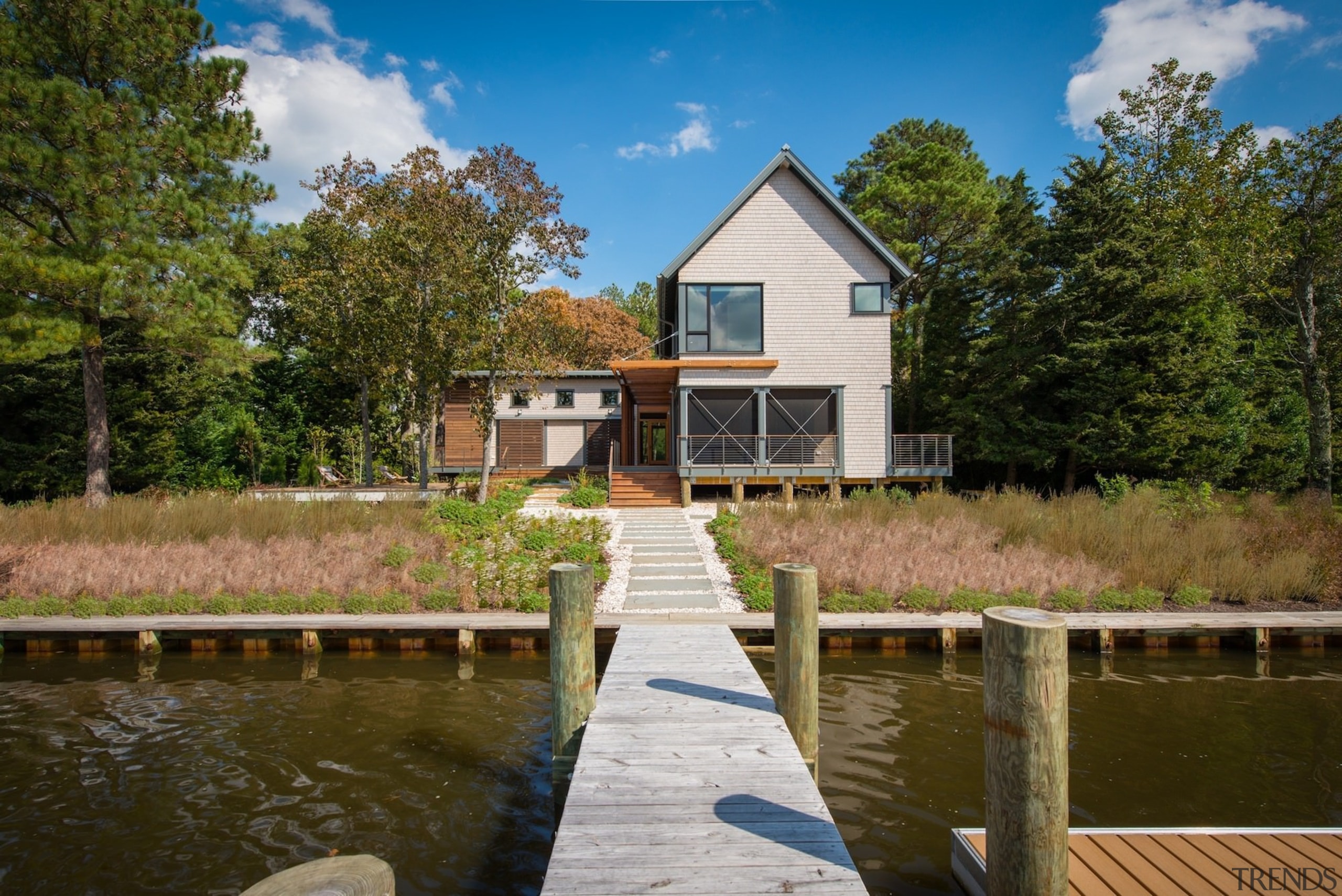 A pier provides access for boats and easy bayou, canal, cottage, estate, farmhouse, home, house, property, real estate, reflection, tree, water, waterway, brown