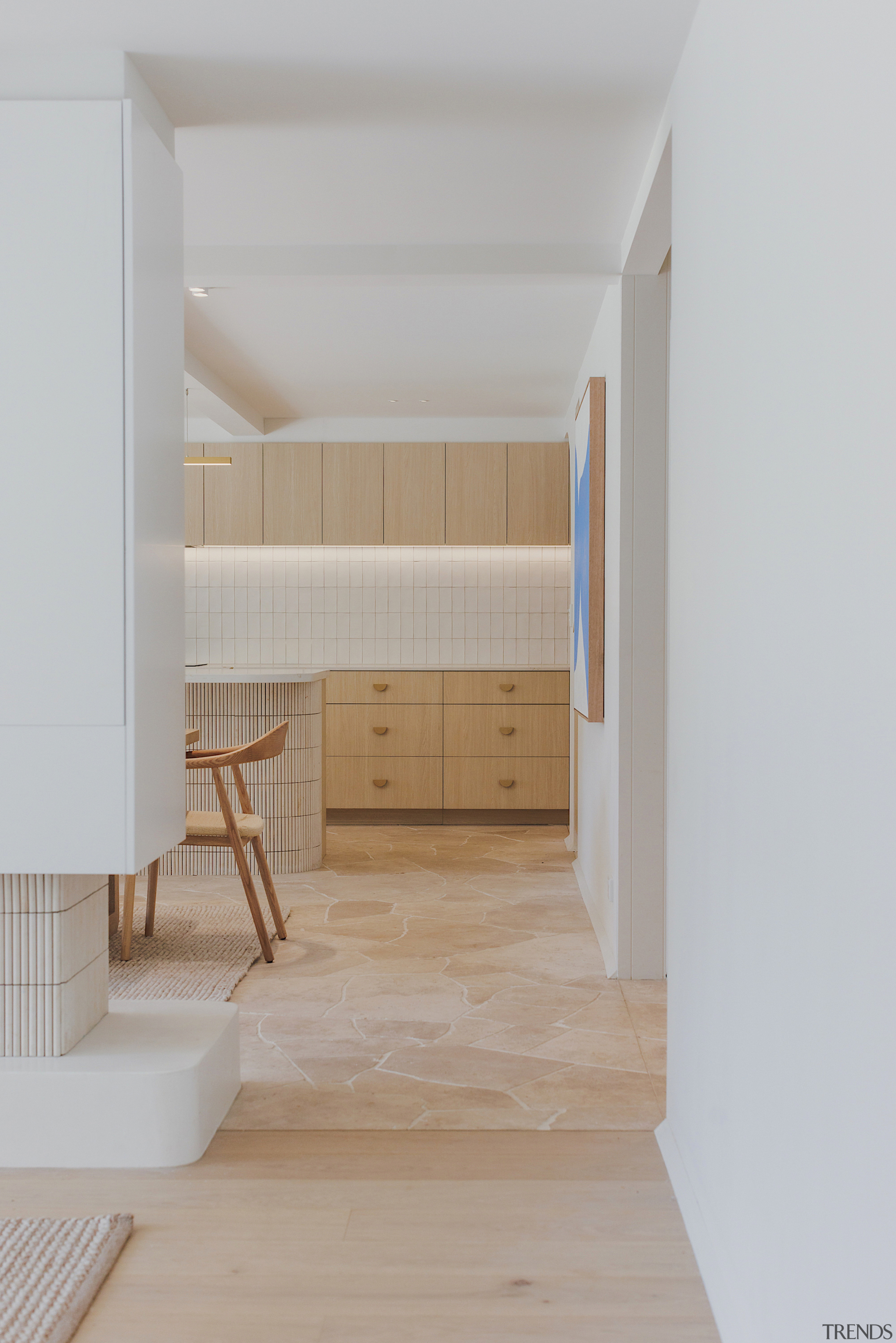 Travertine crazy pave flooring extends throughout the living 