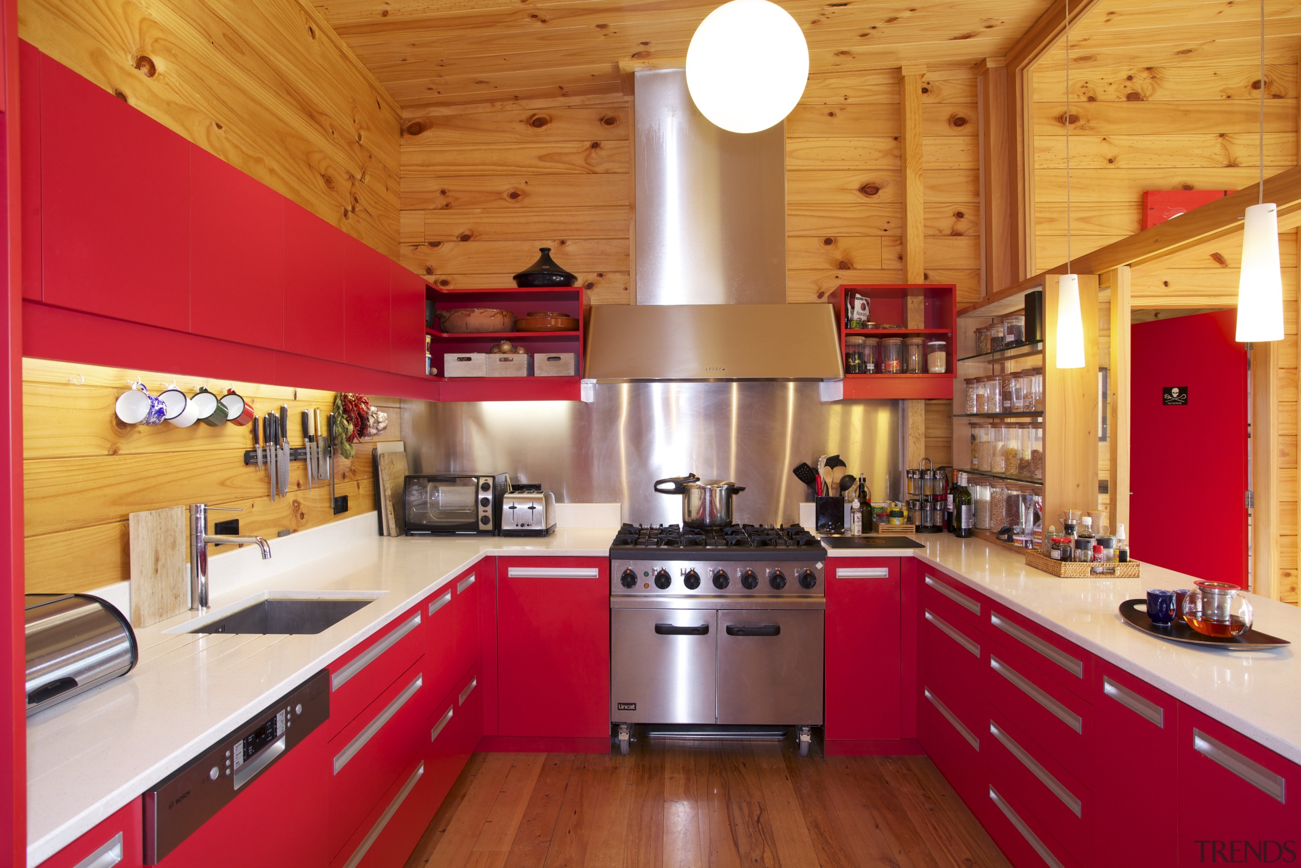 Cedar cladding wraps the exterior of this Lockwood ceiling, countertop, cuisine classique, interior design, kitchen, real estate, room, red, orange