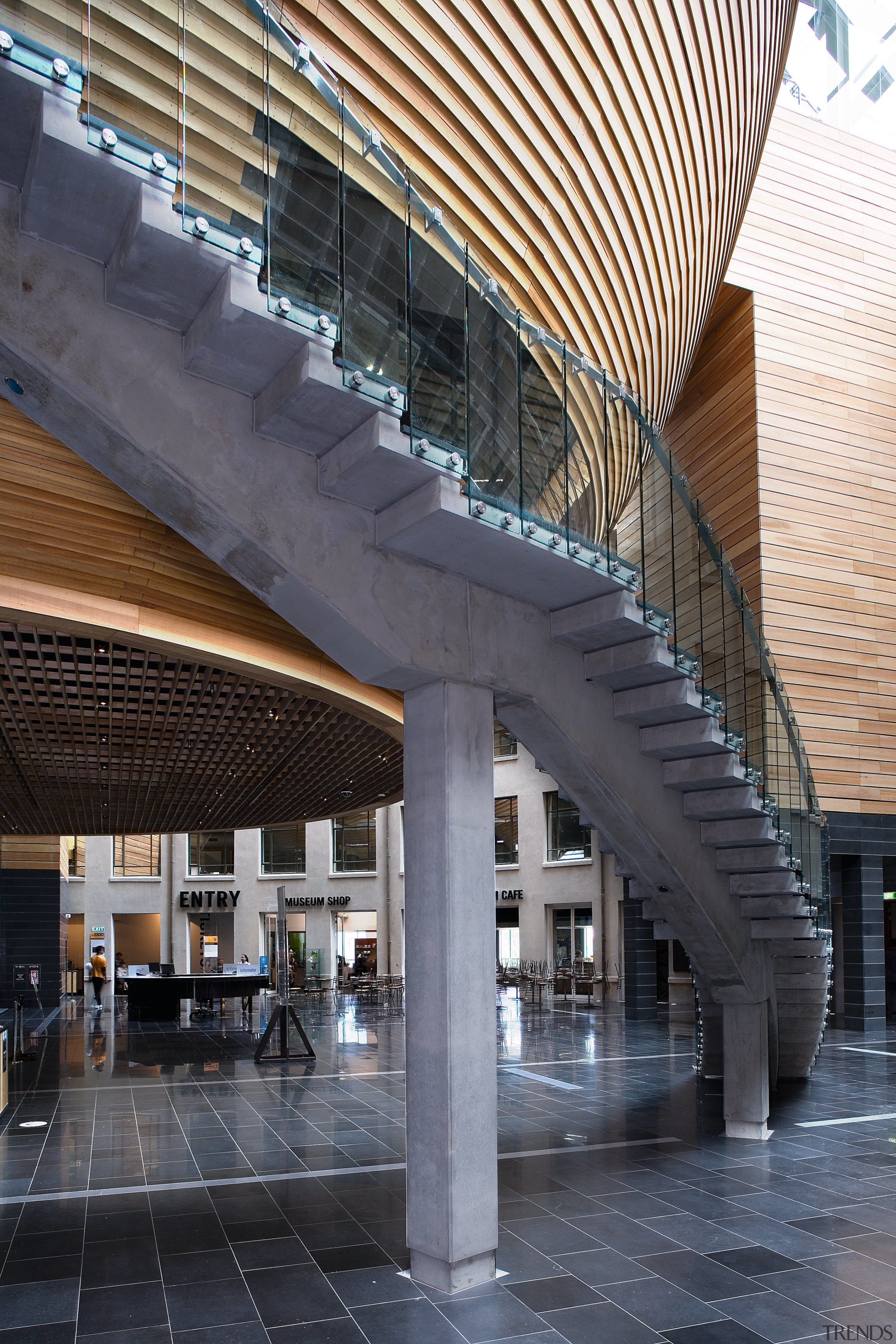 A view of the curved concrete staircase in architecture, building, daylighting, landmark, metropolitan area, mixed use, structure, tourist attraction, black, gray