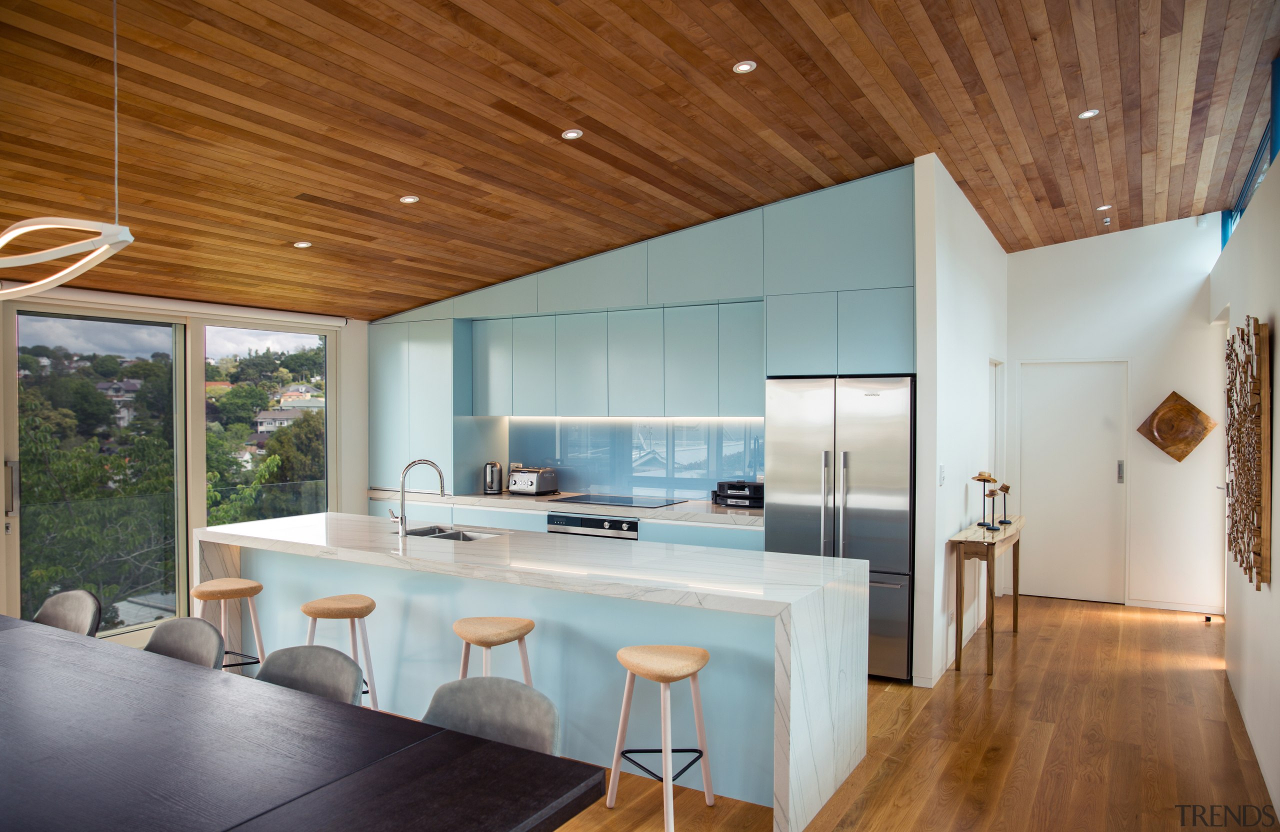 ​​​​​​​Finished in powder blue and defined by the architecture, ceiling, countertop, floor, house, interior design, table, wood, gray, brown, timber floor, Frans Kamermans