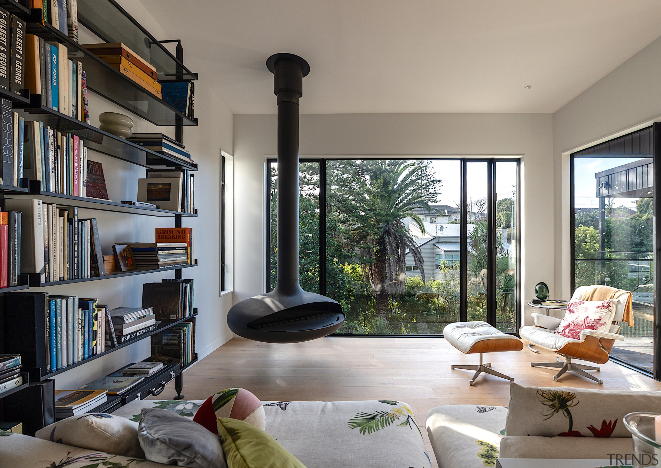 Living room with feature suspended fire running on 