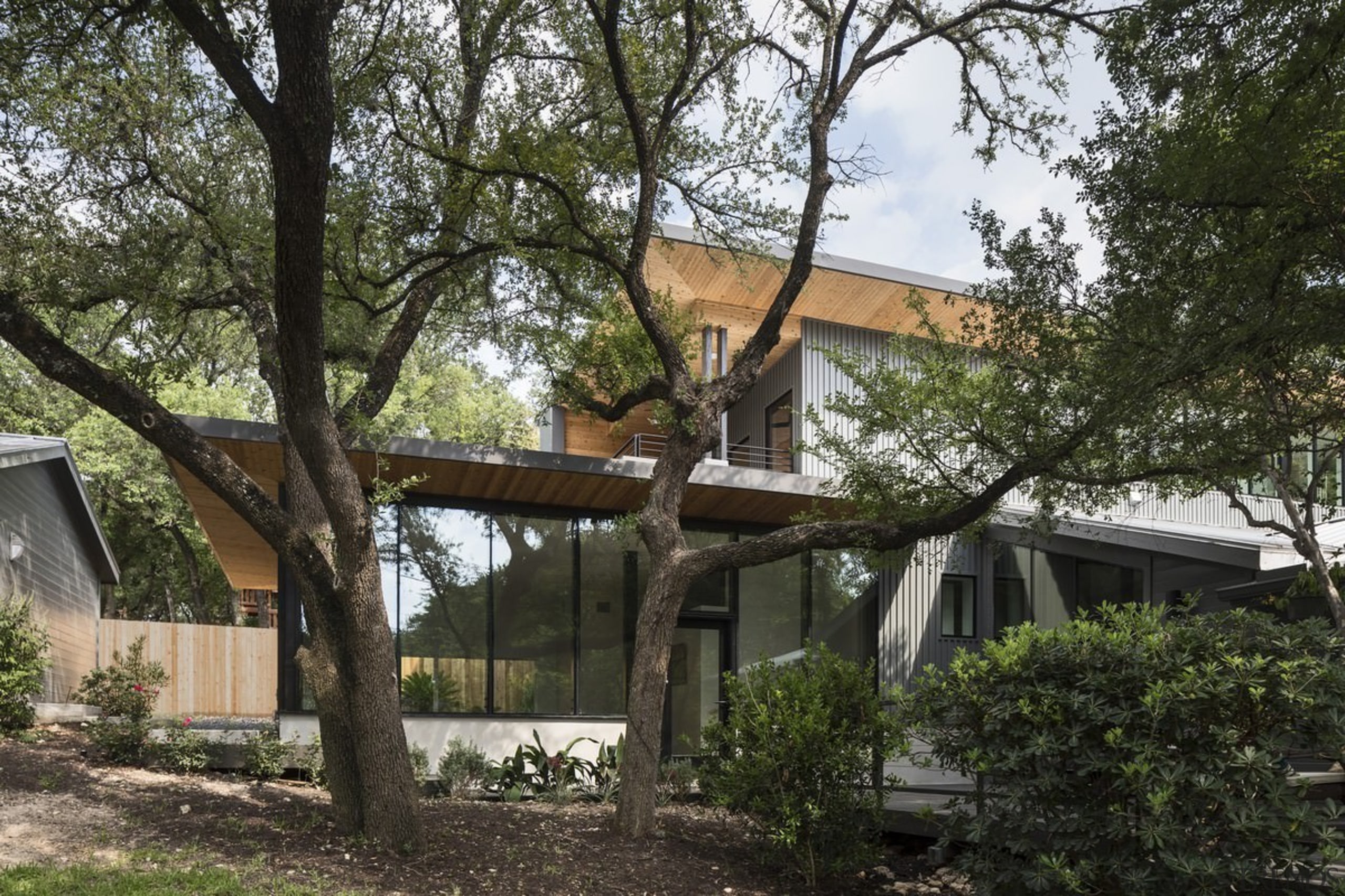 The home is hidden among the trees - architecture, cottage, home, house, outdoor structure, plant, property, real estate, tree, black, brown