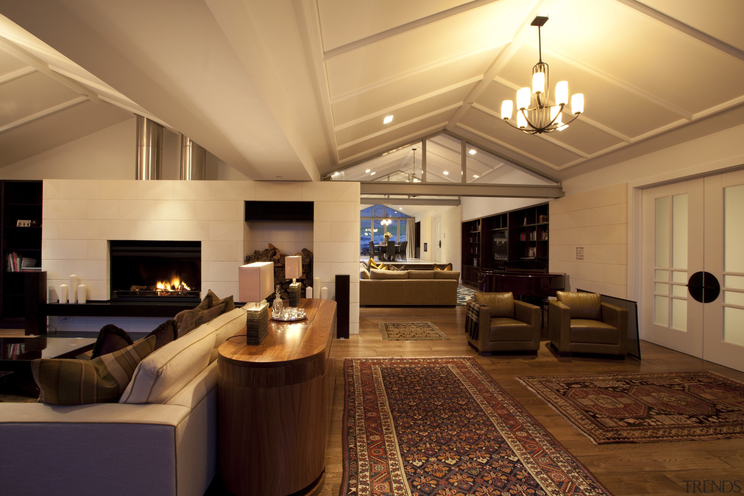 View of the living area, fireplace from Warmington. ceiling, home, interior design, lighting, living room, real estate, room, orange, brown