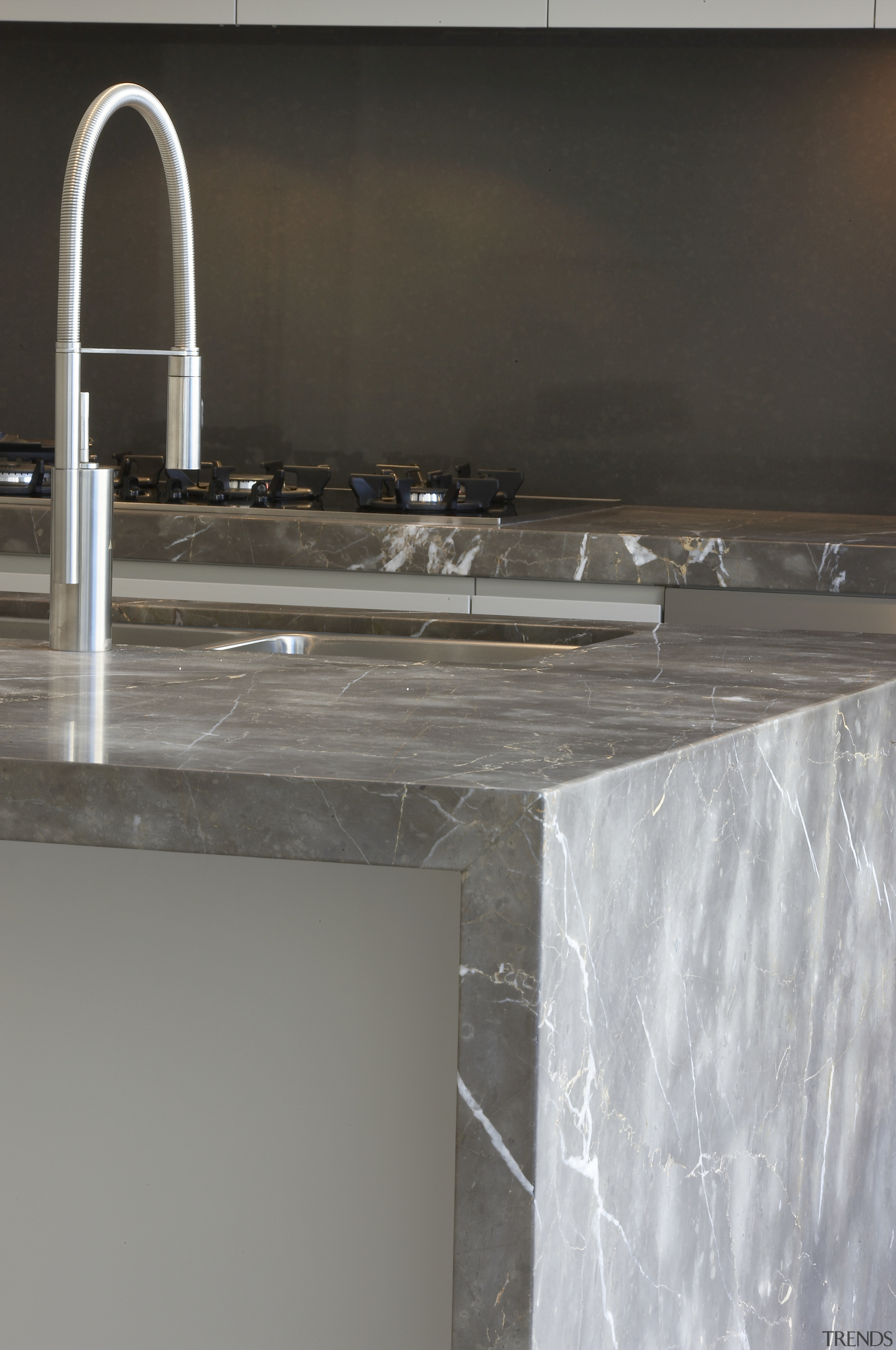 Grey and brown marble island benchtop, white walls, countertop, floor, plumbing fixture, sink, tap, gray, black
