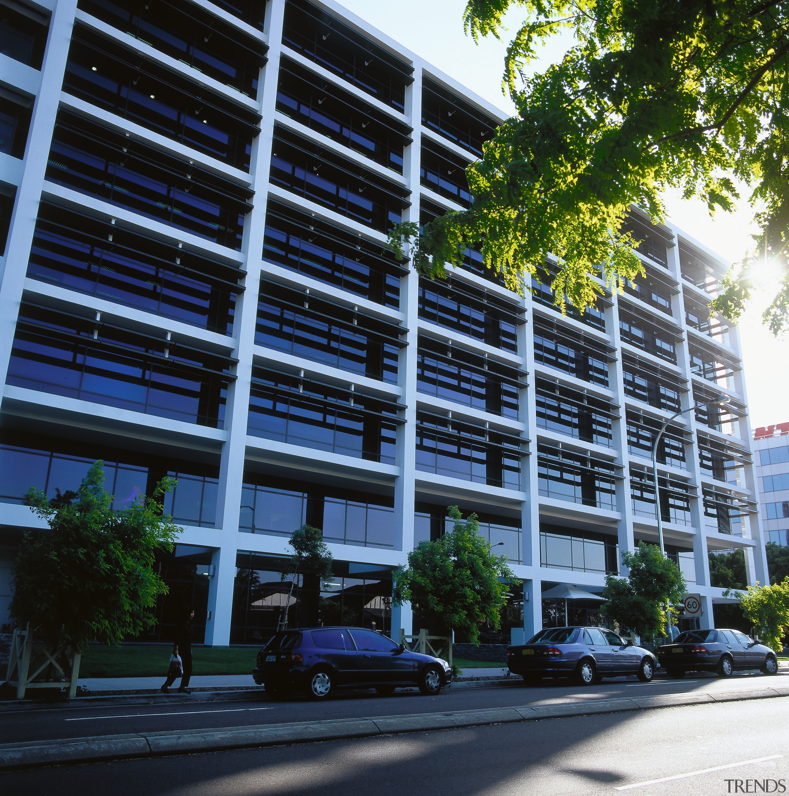 Exterior view of the TNT Australia building from apartment, architecture, building, car, city, commercial building, condominium, corporate headquarters, daytime, facade, headquarters, house, luxury vehicle, metropolitan area, mixed use, neighbourhood, parking, real estate, residential area, tree, window, black