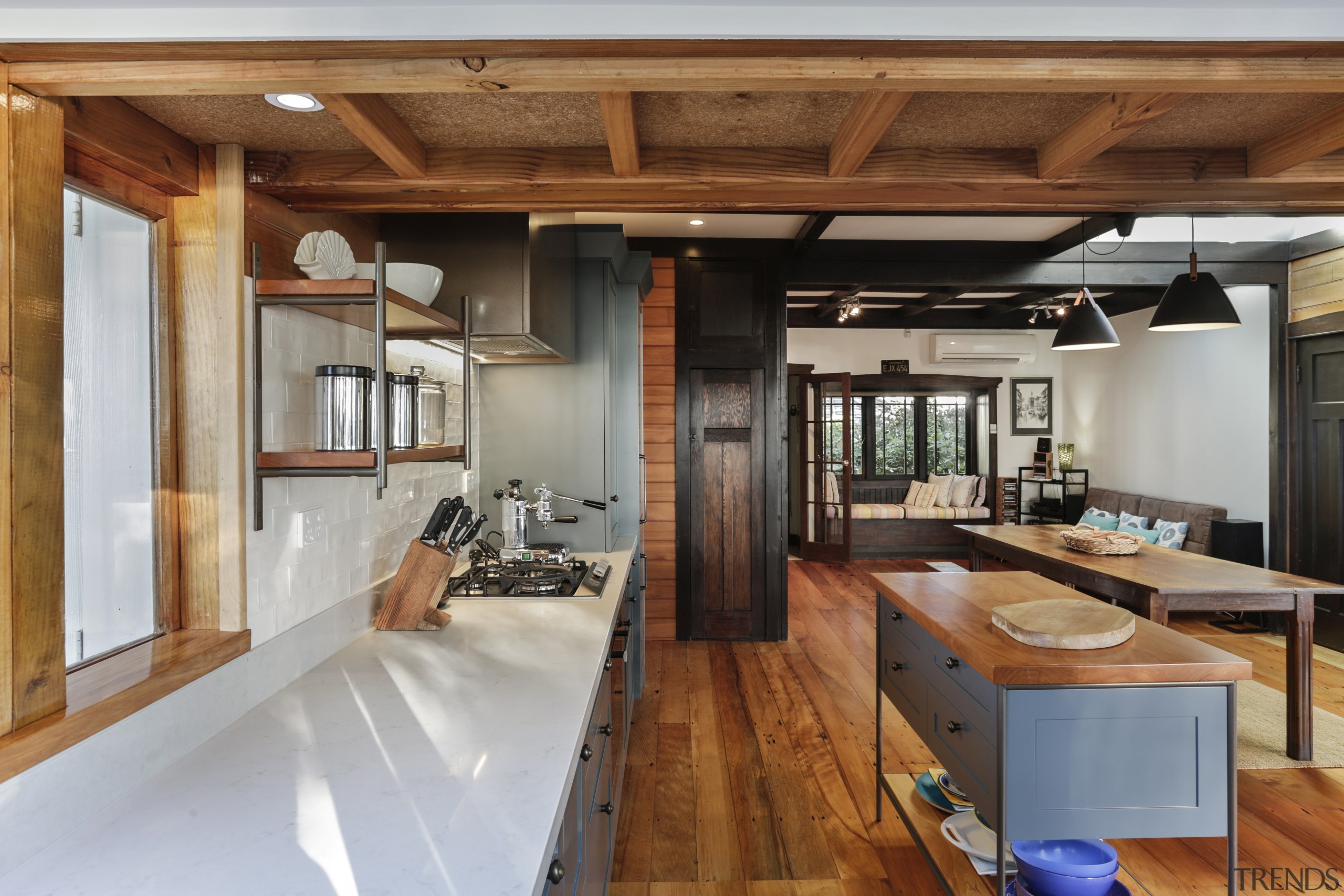 The generous use of wood in the design architecture, beam, building, ceiling, countertop, design, dining room, estate, floor, flooring, furniture, hardwood, home, house, interior design, kitchen, living room, loft, plywood, property, real estate, room, table, wood, wood flooring, wood stain, brown, gray