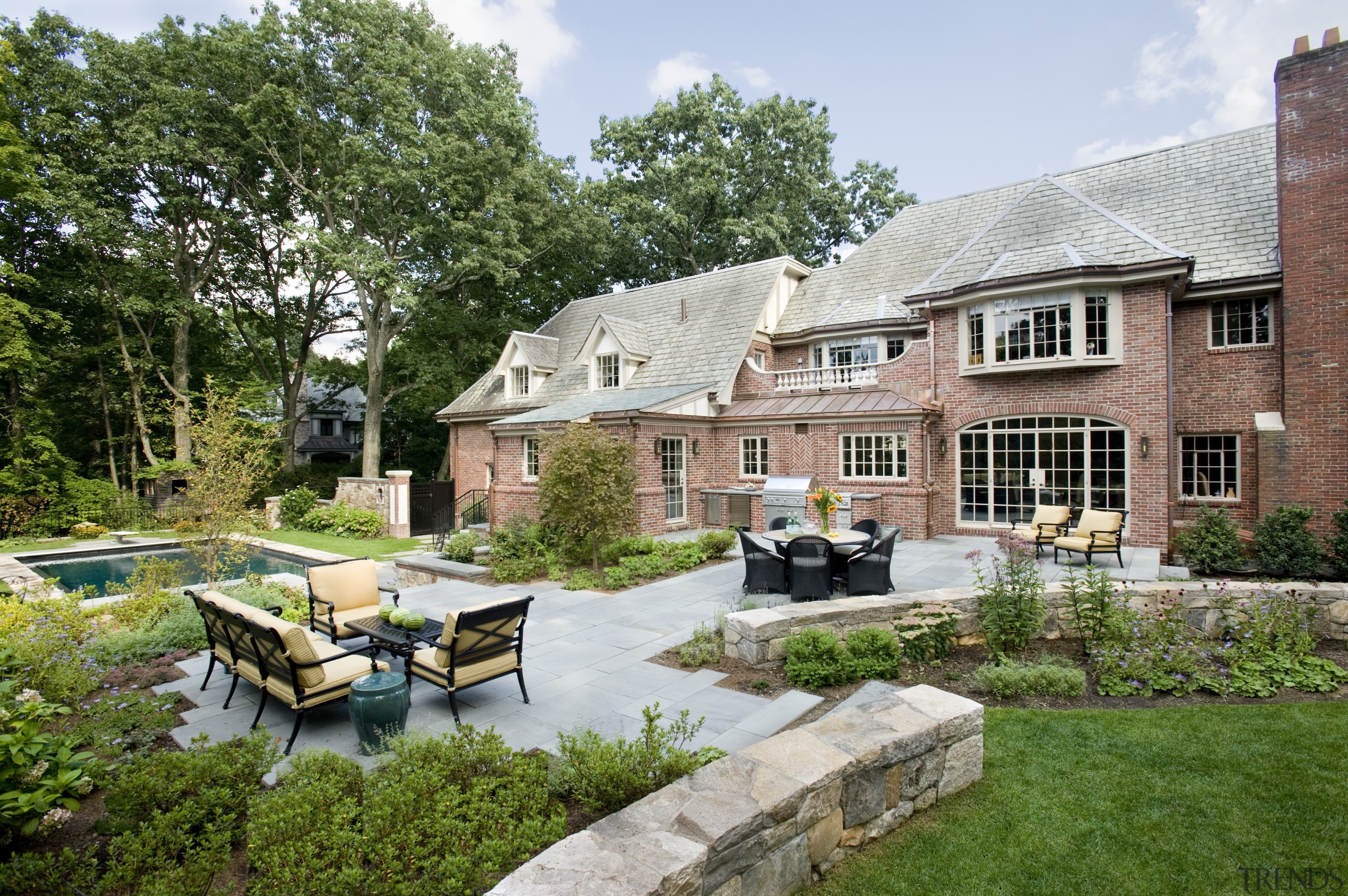 An extensive remodeling project has transformed this 1920s backyard, cottage, courtyard, estate, farmhouse, garden, home, house, landscape, landscaping, outdoor structure, property, real estate, yard