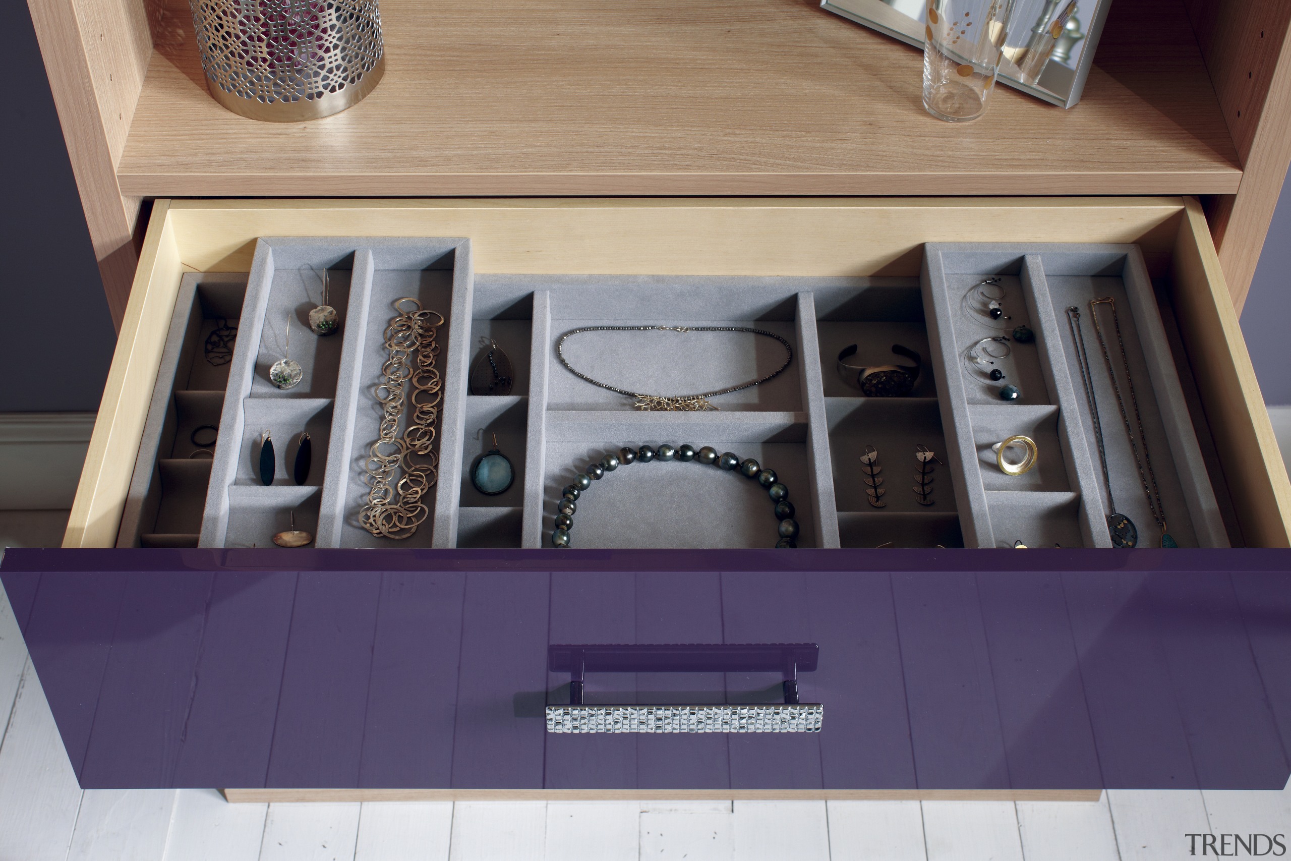 Seen here is a storage system/closet designed and drawer, furniture, interior design, purple, table, purple