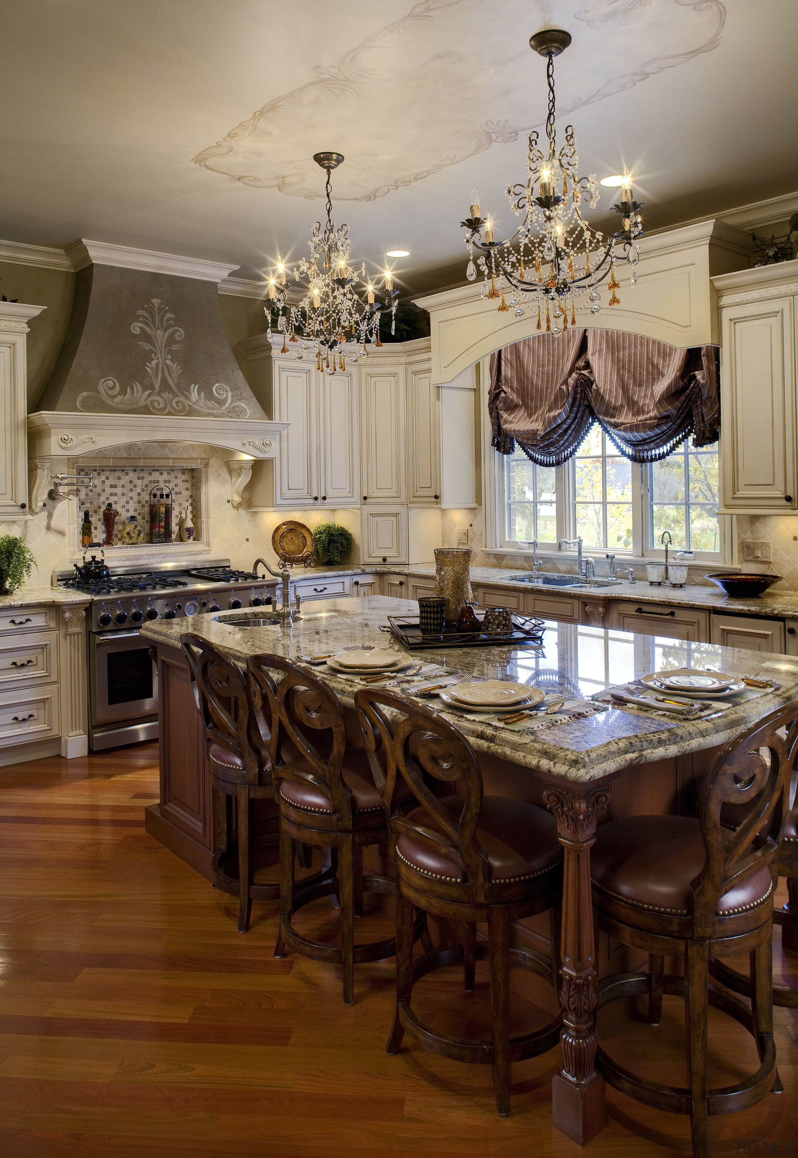 View of a kitchen which is centrally located cabinetry, ceiling, chandelier, countertop, cuisine classique, dining room, furniture, home, interior design, kitchen, room, table, brown