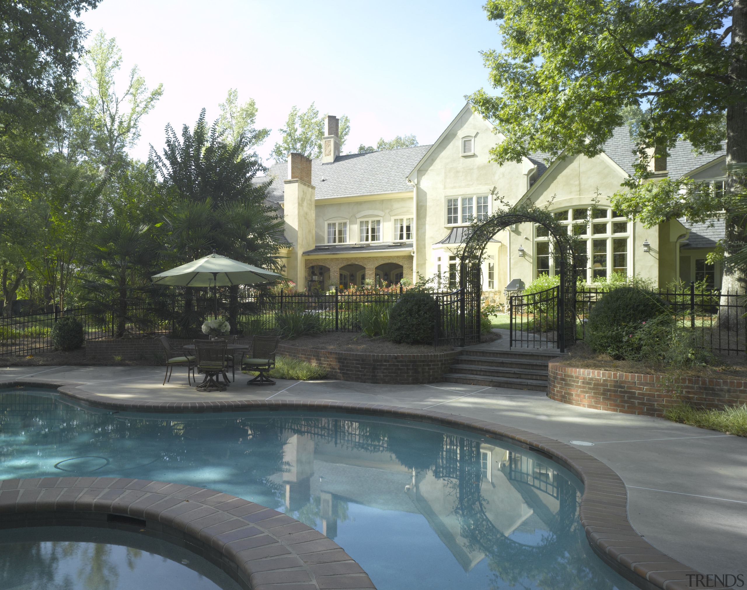 View of exterior, pool, shingled roof, chimneys landscaping, backyard, cottage, estate, hacienda, home, house, landscaping, mansion, outdoor structure, property, real estate, residential area, resort, swimming pool, villa