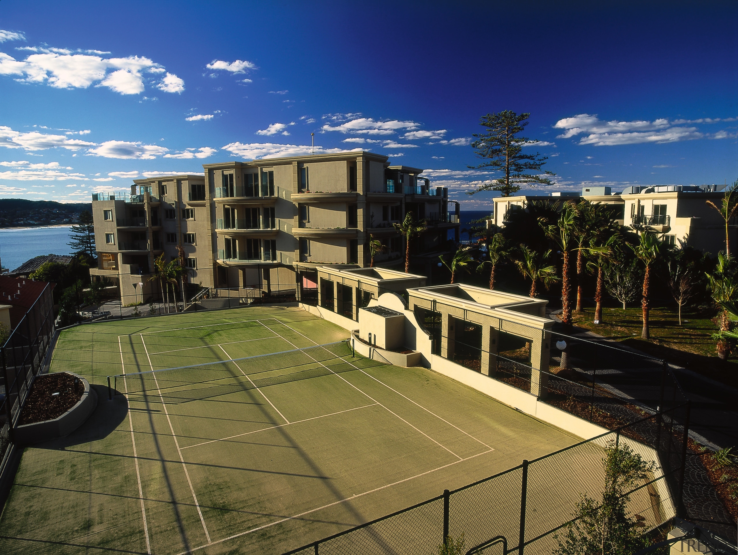 exterior view of tenis courts - exterior view apartment, architecture, building, campus, city, condominium, corporate headquarters, estate, mixed use, neighbourhood, property, real estate, residential area, roof, sky, structure, suburb, urban area, urban design, brown, black, blue