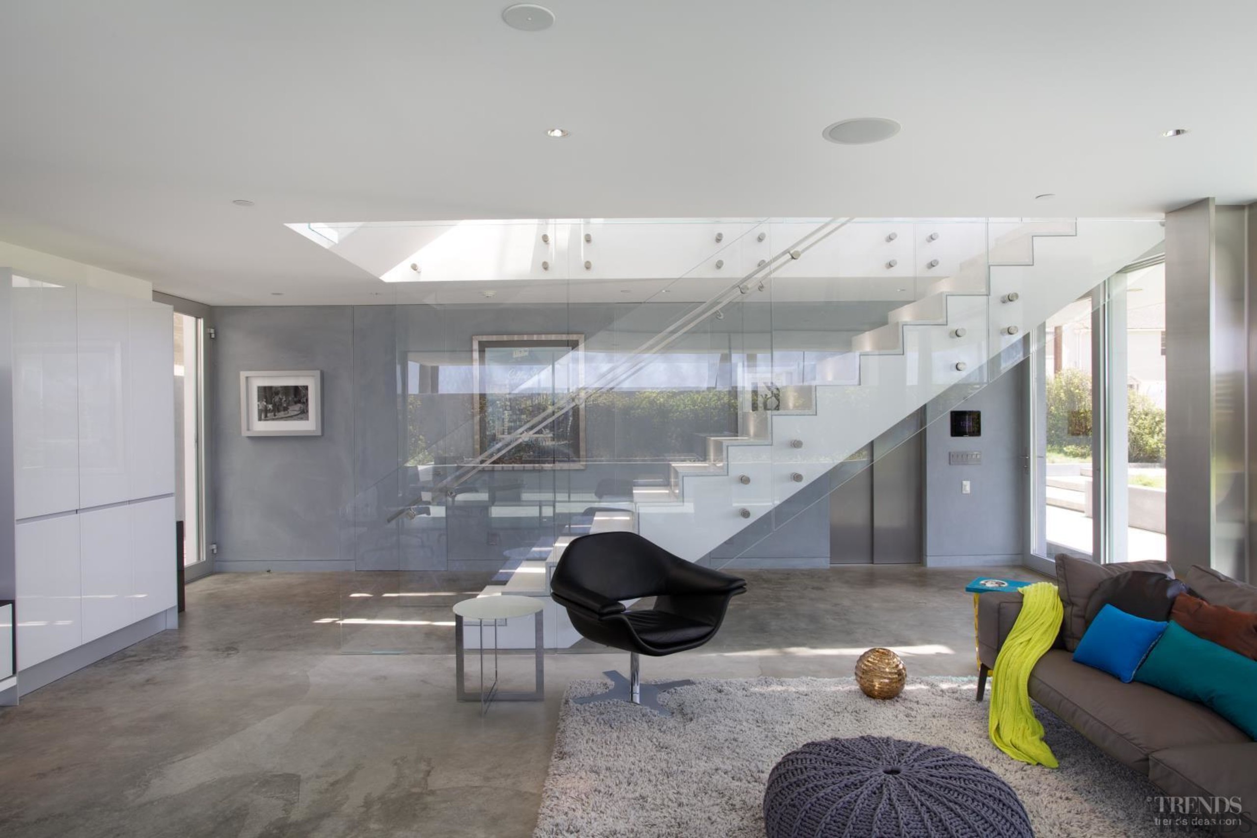 The first floor of this beachhouse accommodates a apartment, architecture, ceiling, daylighting, floor, house, interior design, living room, lobby, real estate, gray