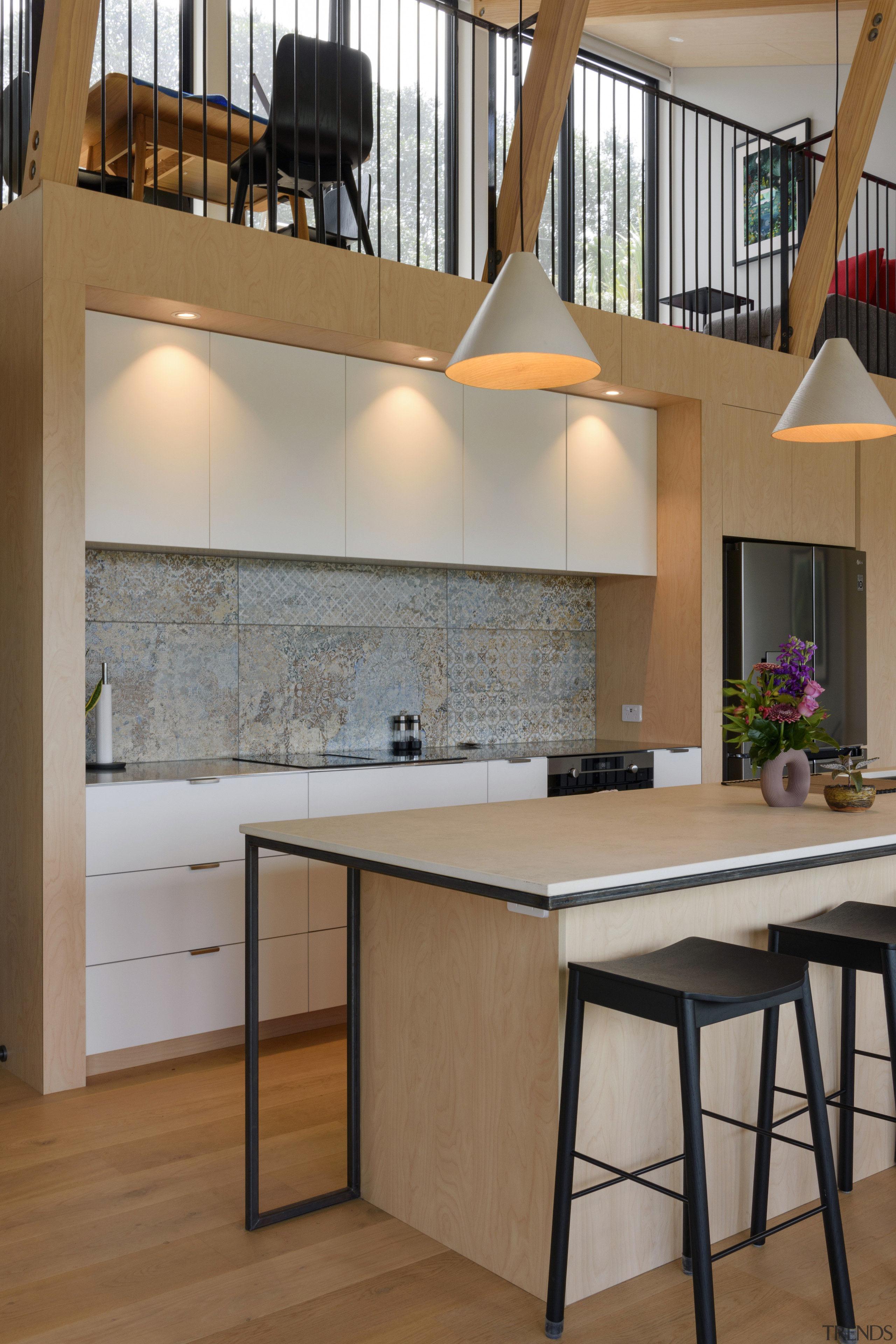 Kitchen, breakfast seating and mezzanine floor above. 