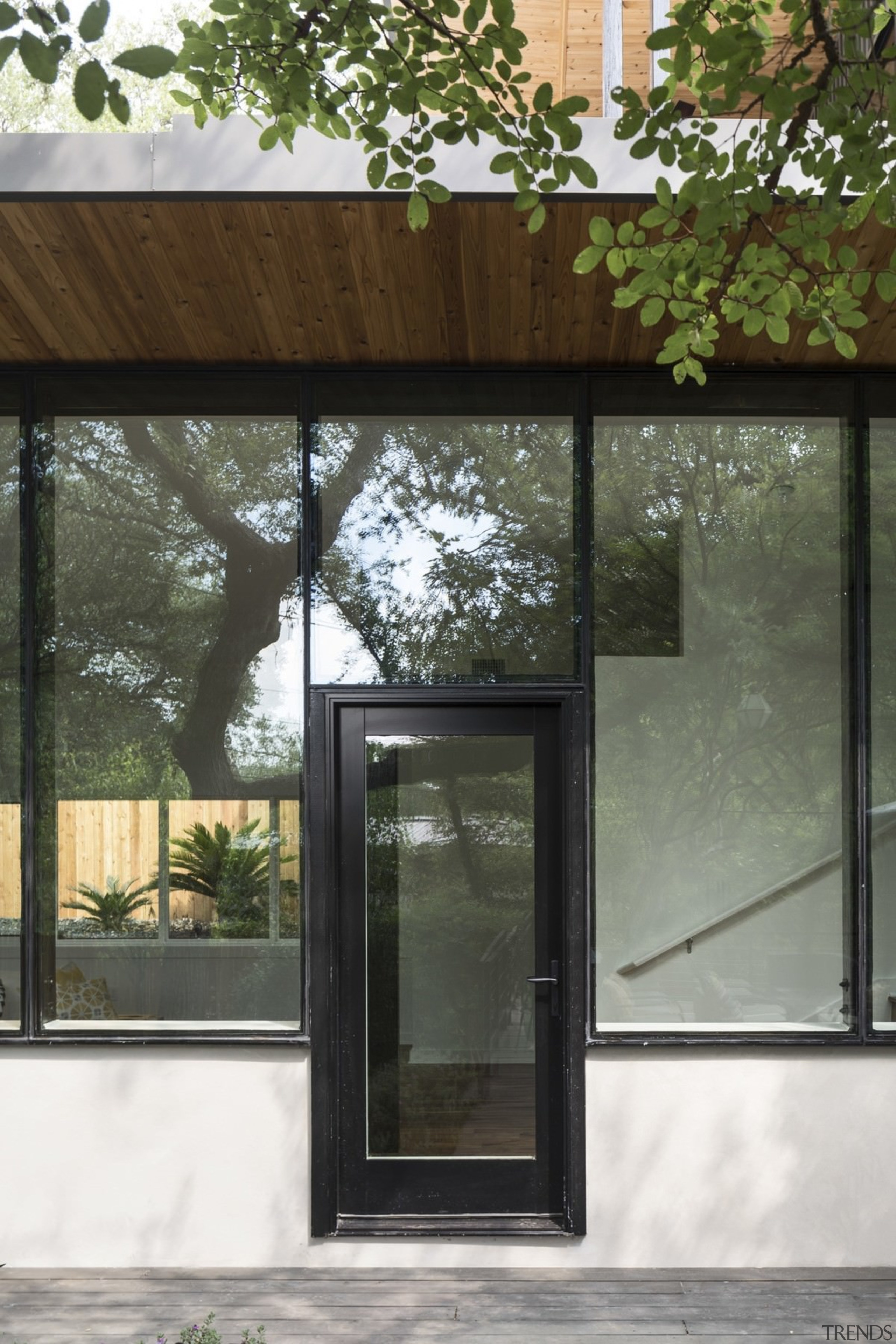 The front entrance is welcoming, with windows ringing architecture, door, facade, glass, house, window, gray