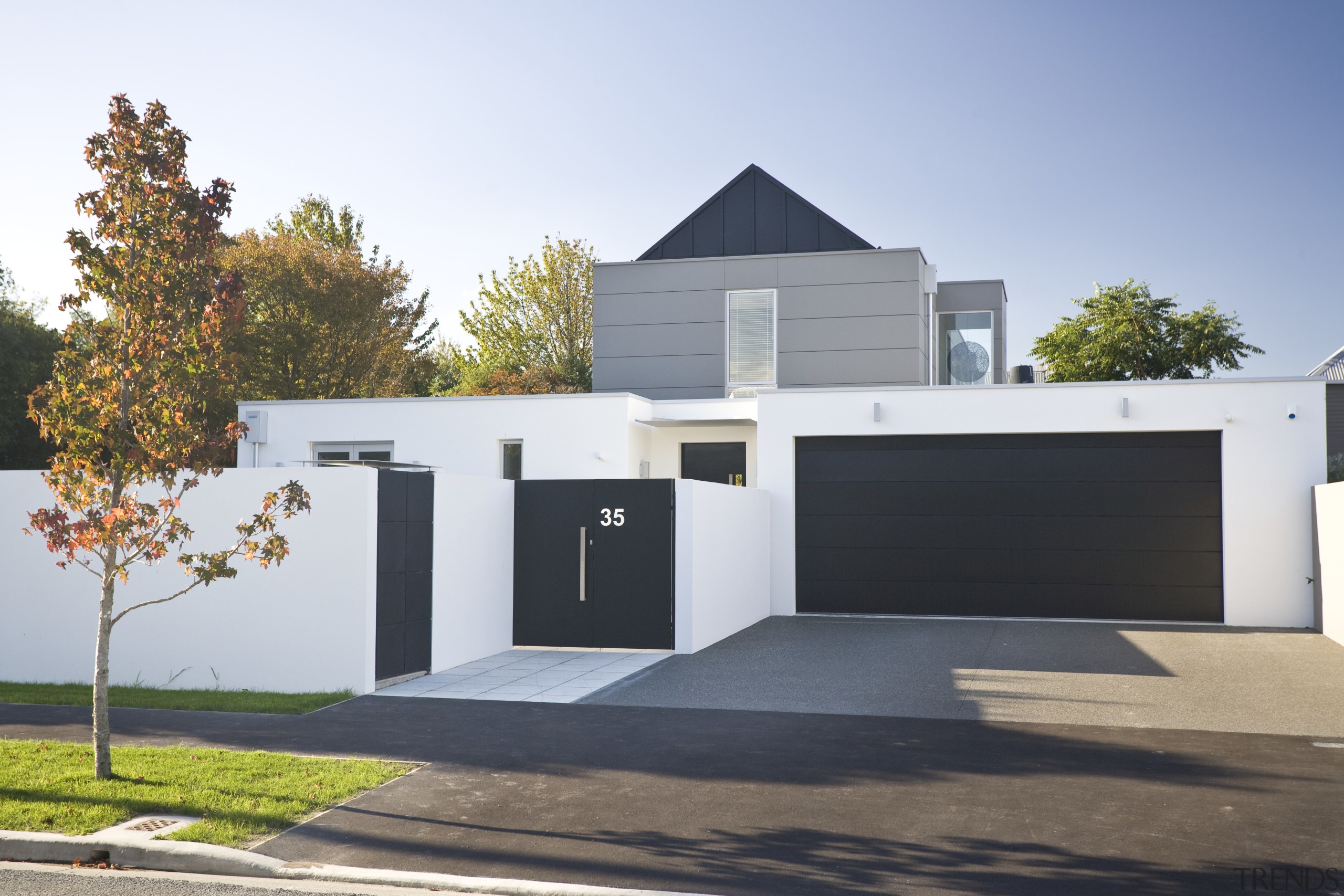 Exterior view of the facade which shows the architecture, building, elevation, facade, garage, home, house, property, real estate, residential area, white