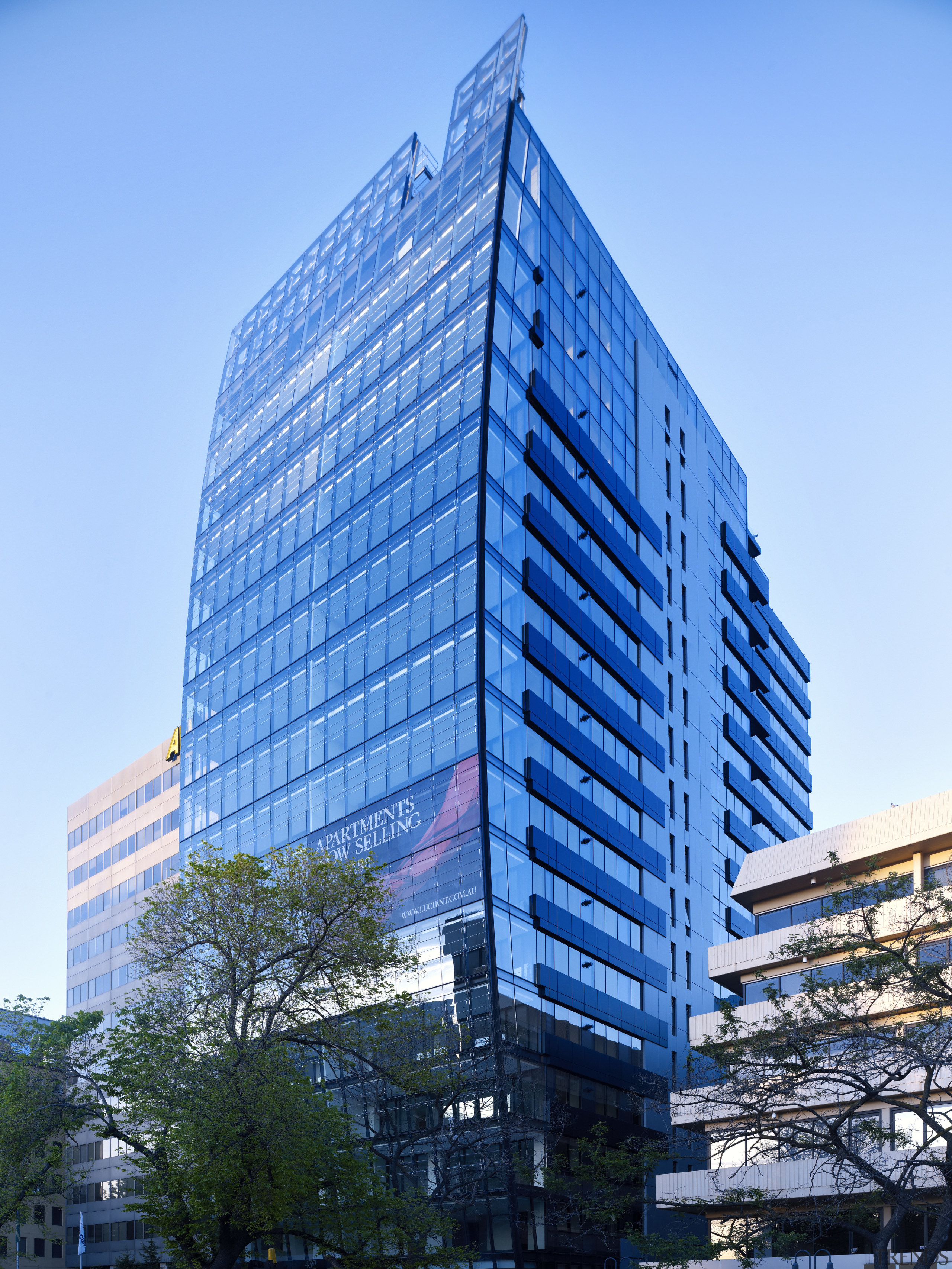 Exterior view of the Lucient apartments in Melbourne architecture, building, city, commercial building, condominium, corporate headquarters, daytime, downtown, facade, headquarters, hotel, landmark, metropolis, metropolitan area, mixed use, neighbourhood, real estate, reflection, residential area, sky, skyscraper, tower, tower block, urban area, teal