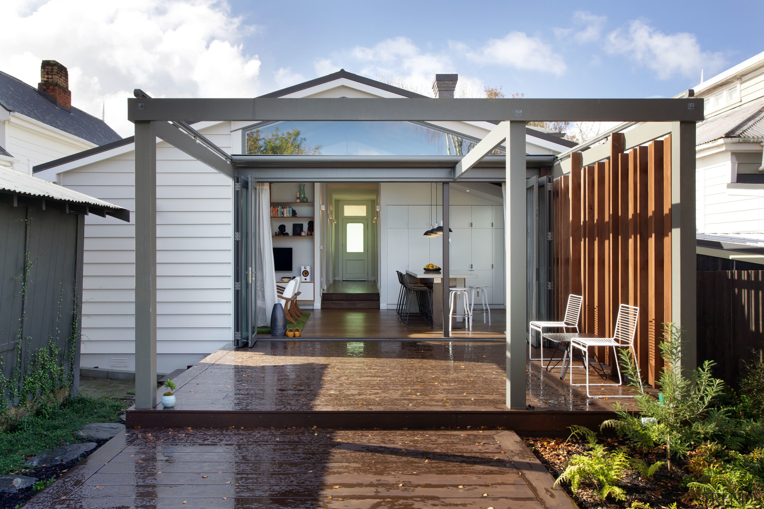 The new family living area in an extension backyard, cottage, deck, facade, home, house, outdoor structure, porch, property, real estate, siding, white