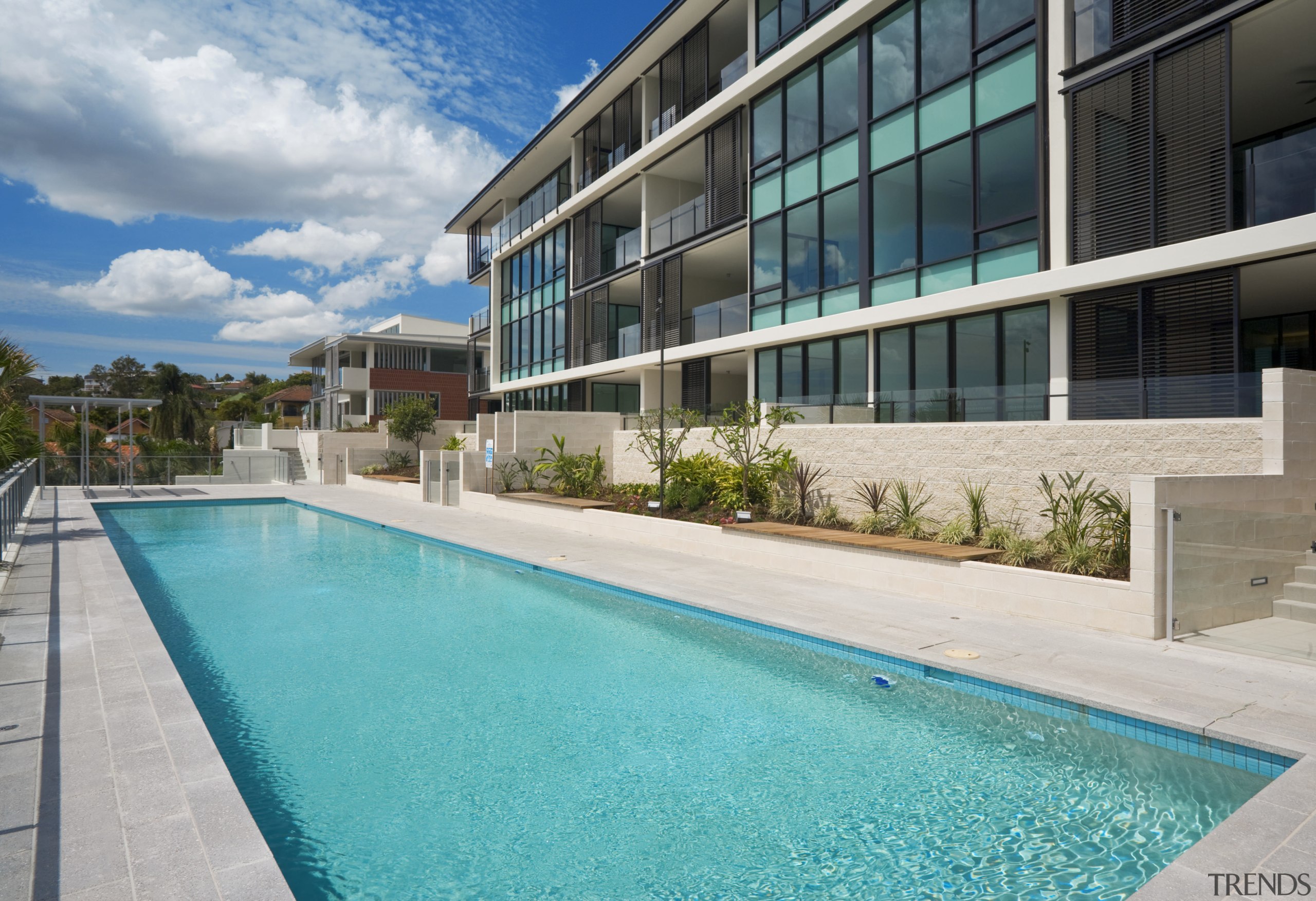 View of the Norman Reach development which is apartment, condominium, estate, home, house, leisure, leisure centre, property, real estate, residential area, resort, sky, swimming pool, villa, water, teal, gray