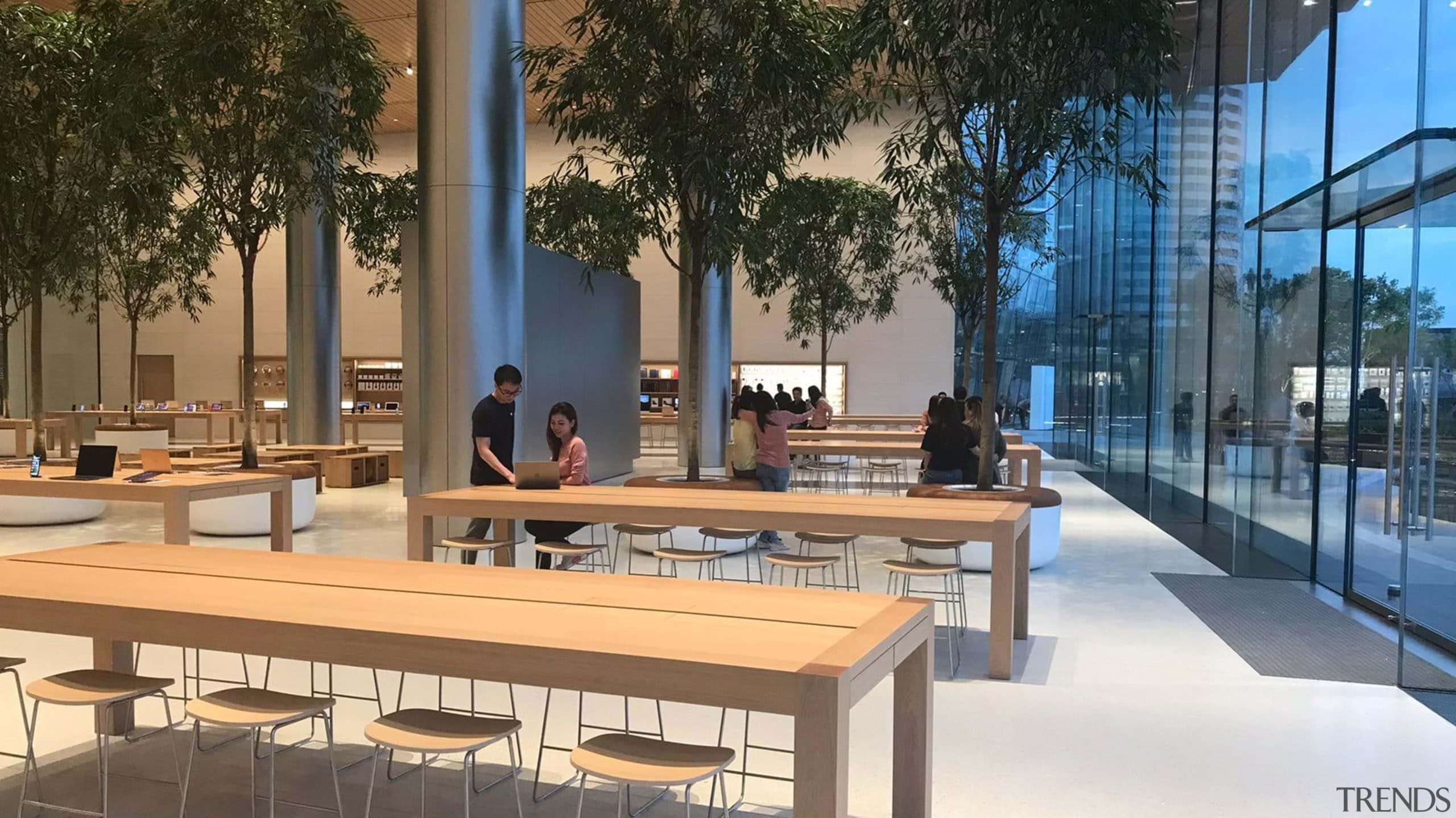 The store’s clean, trapezoidal design lines and glass architecture, furniture, mixed use, table, brown