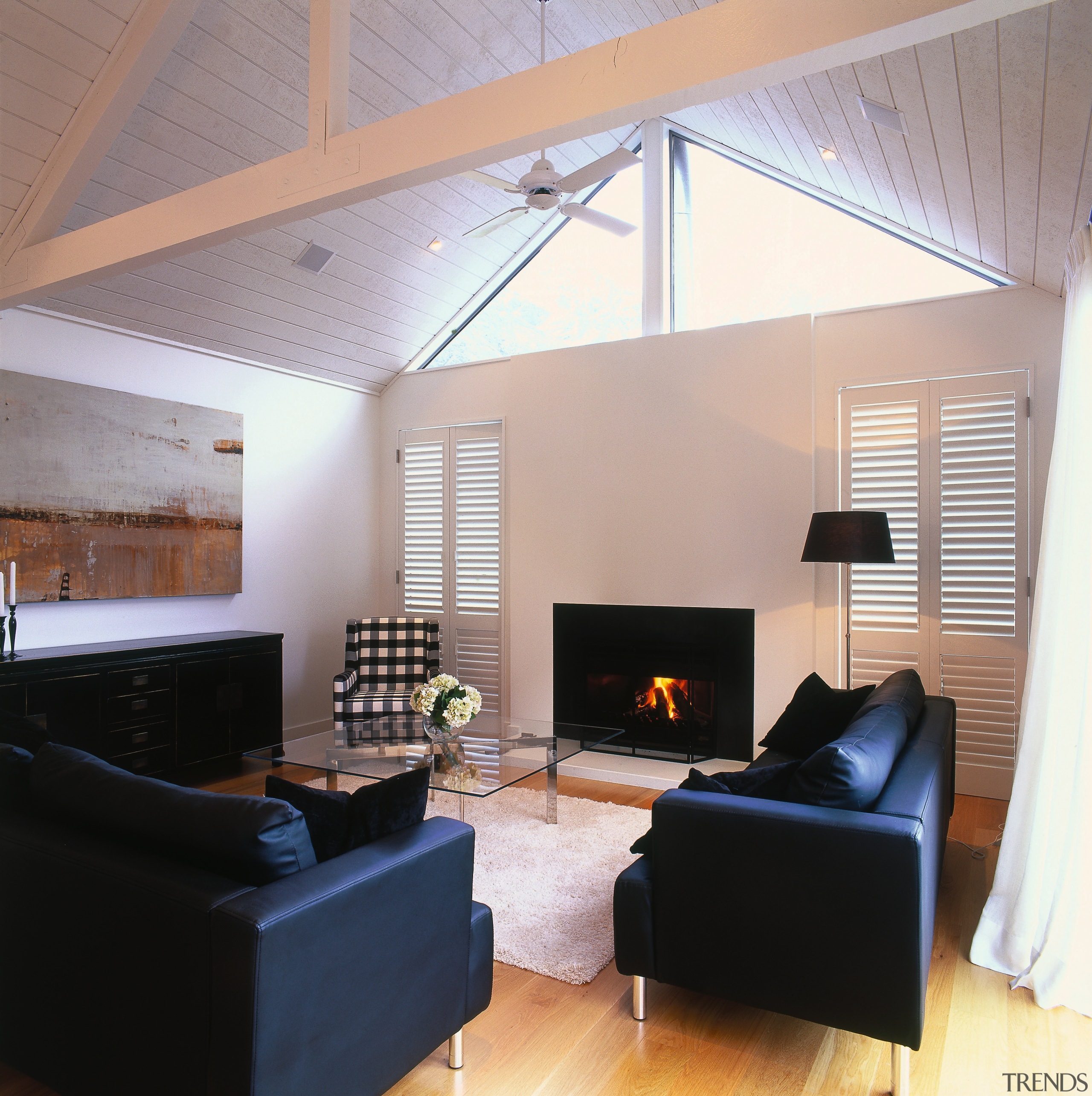 A view of the living area featuring black architecture, ceiling, daylighting, floor, flooring, hardwood, hearth, house, interior design, interior designer, living room, loft, real estate, room, wood, wood flooring, gray