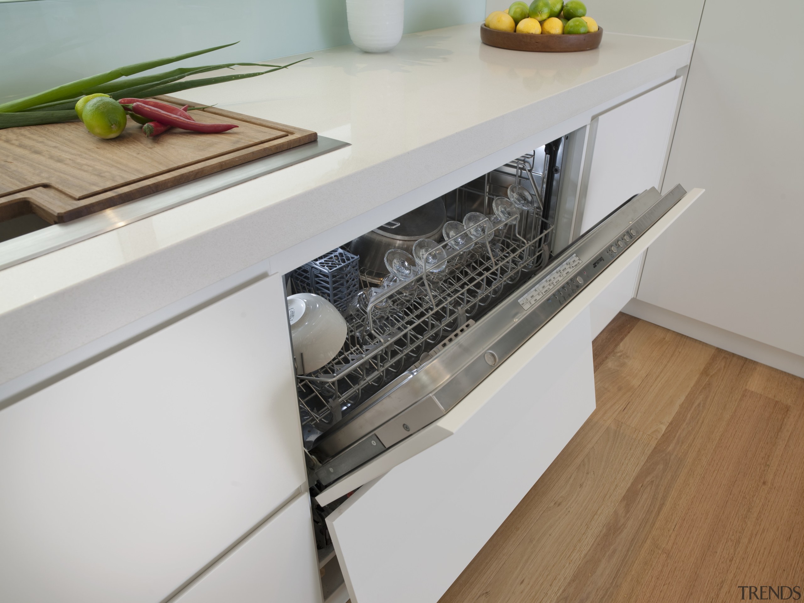 View of open dishwasher in contemporary light-toned kitchen. countertop, drawer, floor, furniture, home appliance, kitchen, kitchen appliance, kitchen stove, major appliance, product design, gray