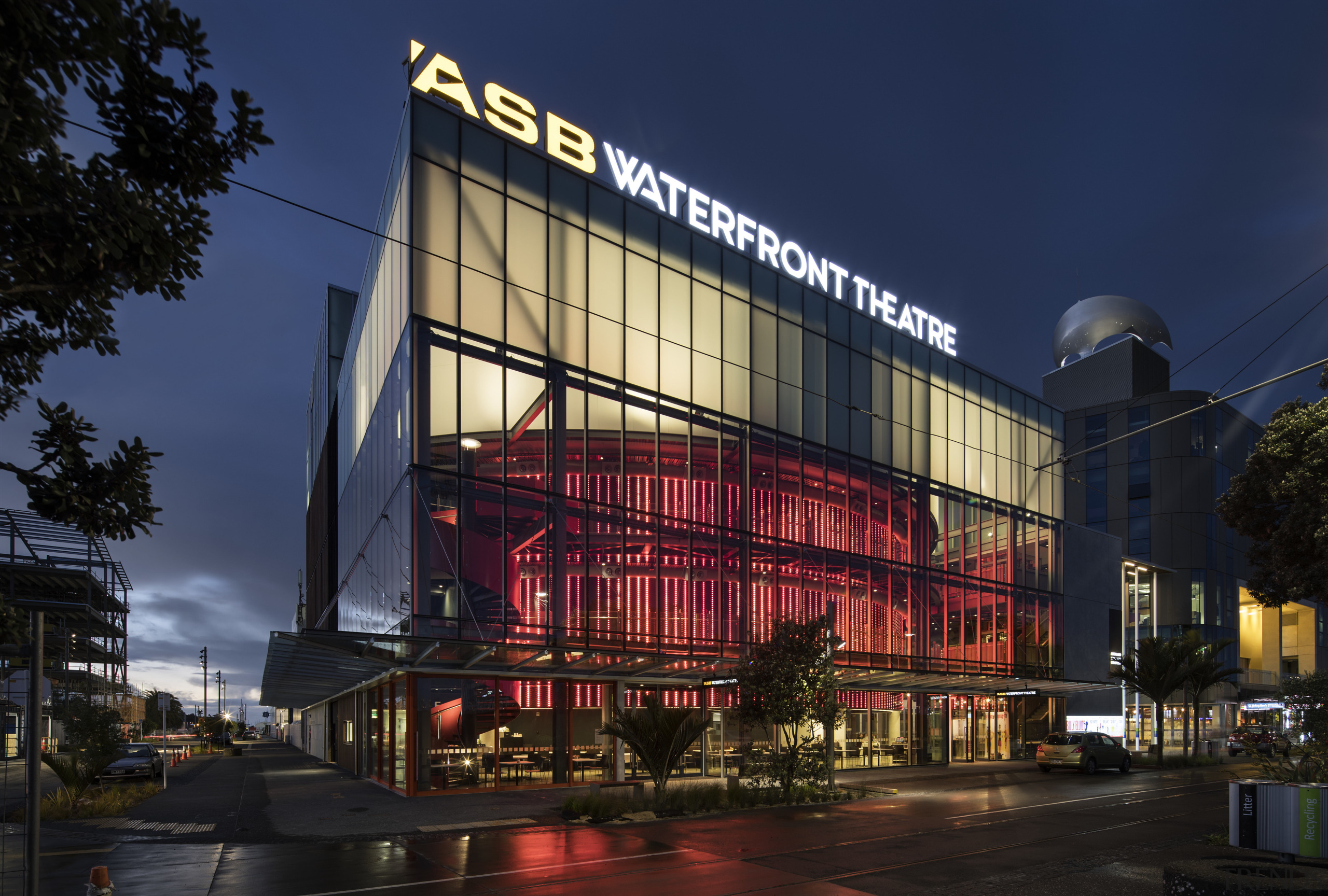 ASB Waterfront Theatre provides a permanent home for architecture, building, city, commercial building, corporate headquarters, downtown, facade, landmark, metropolis, metropolitan area, mixed use, night, sky, blue, black