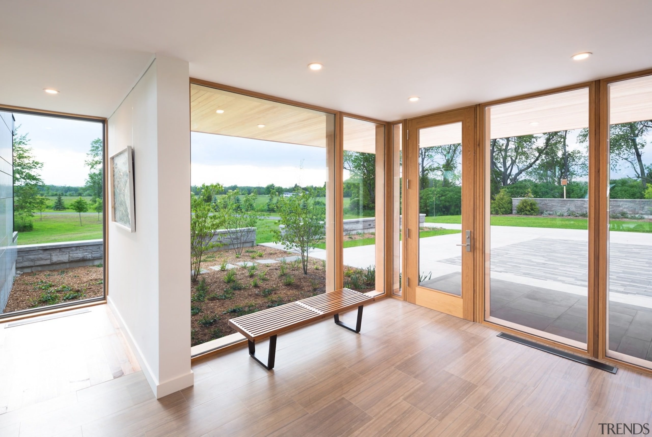 Floor to ceiling windows wrap around the front door, estate, floor, flooring, hardwood, home, house, interior design, property, real estate, window, wood, wood flooring, gray