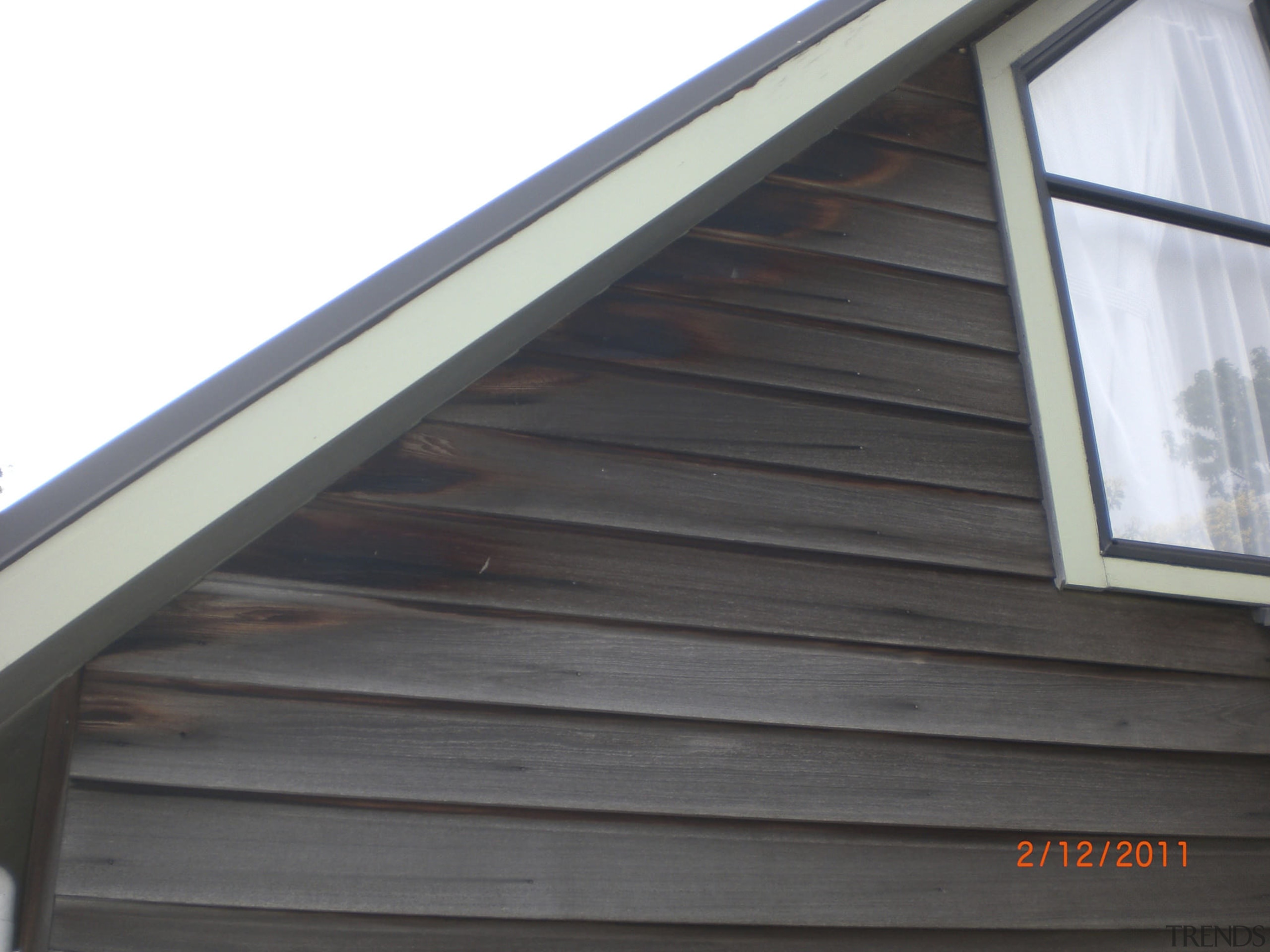 Close up of timber house. - Close up daylighting, facade, handrail, roof, siding, window, wood, wood stain, black, white