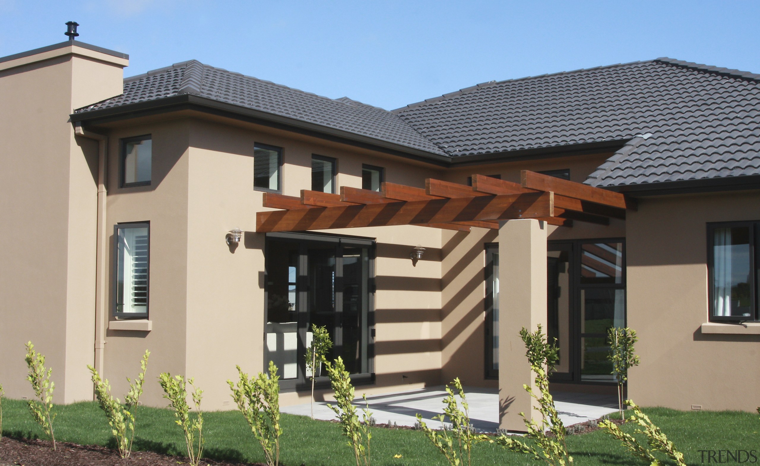 Exterior view of a home designed and built elevation, estate, facade, home, house, outdoor structure, property, real estate, residential area, roof, siding, window, orange