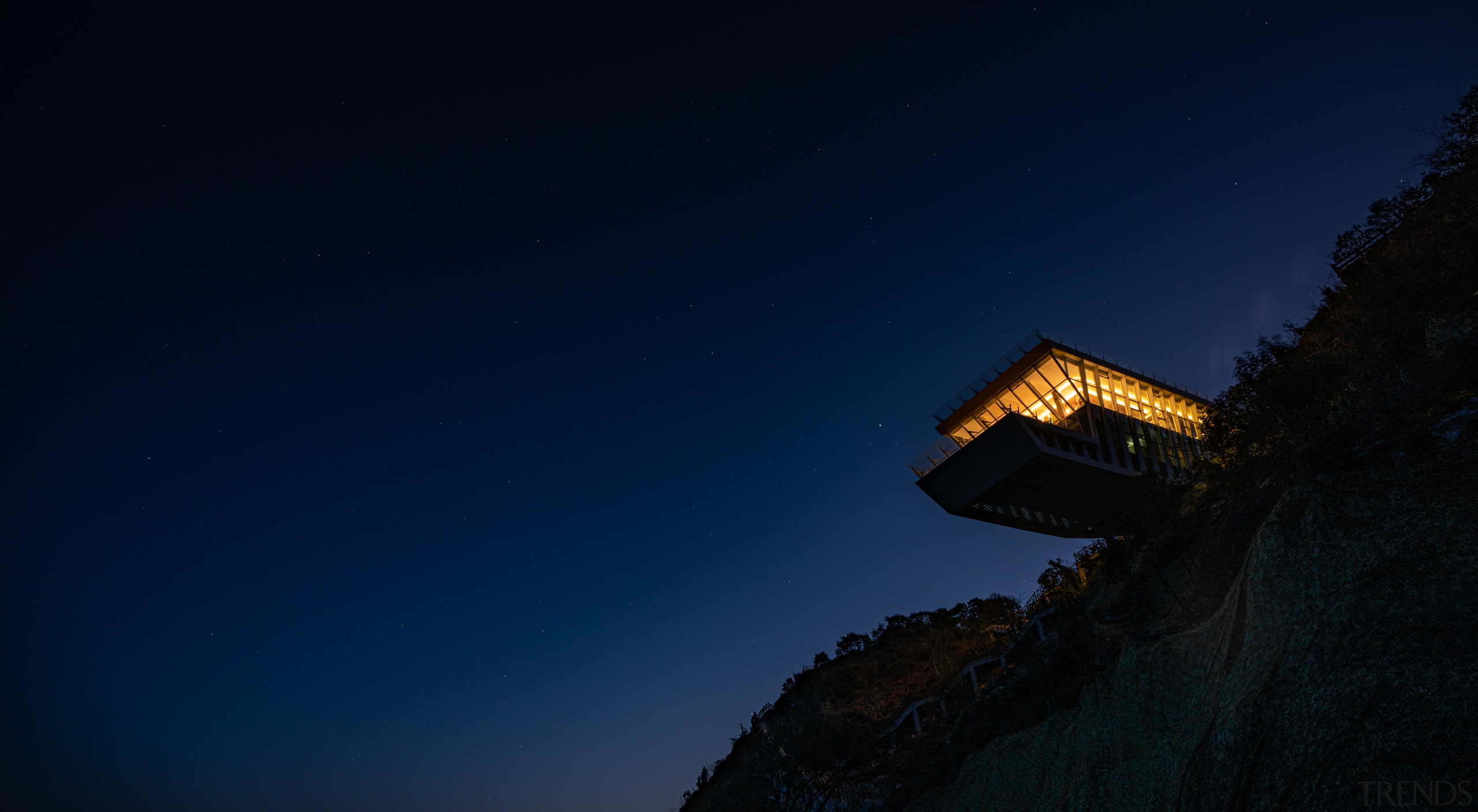 The sculptural hotel seen from below at night. 