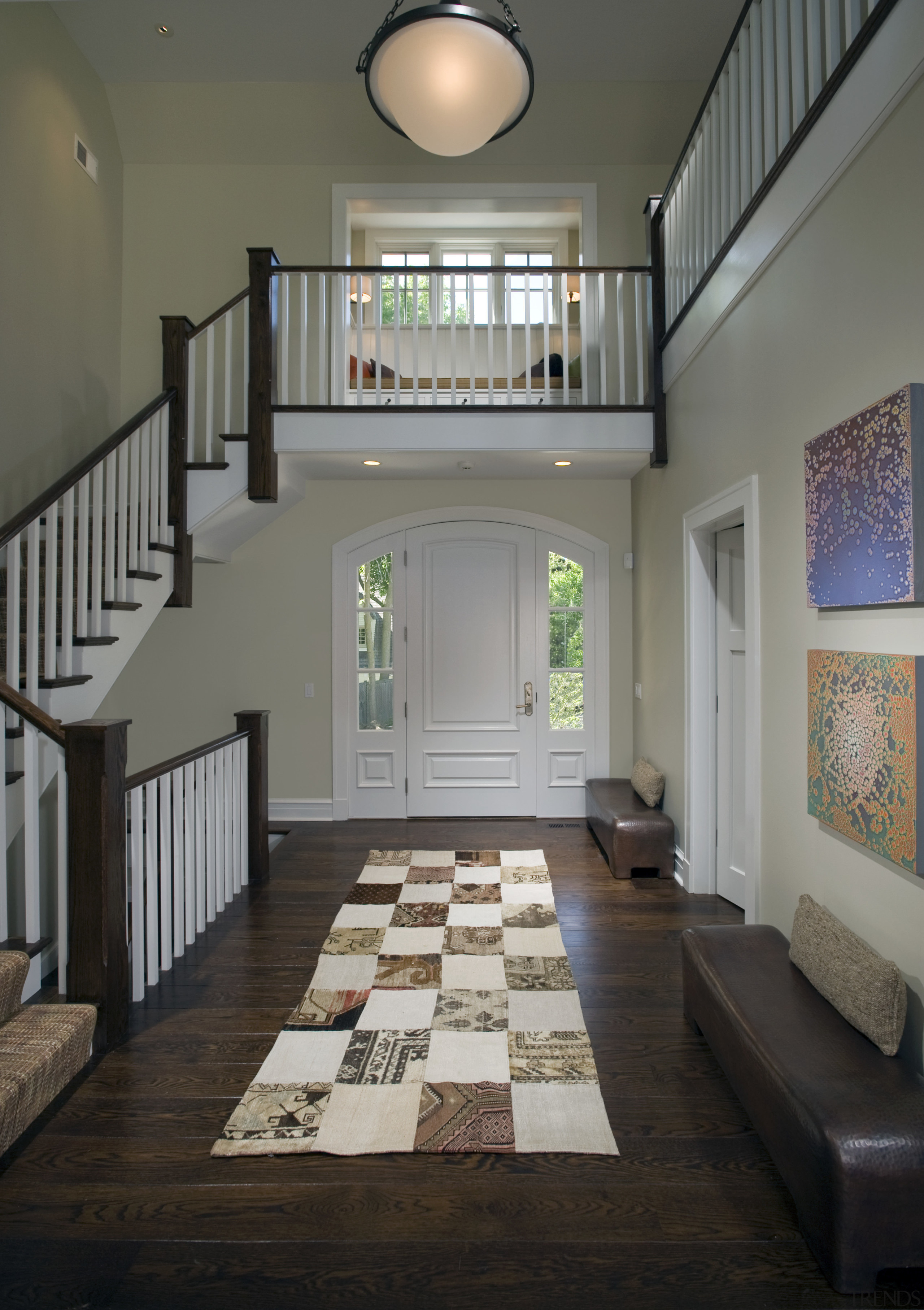 View of stairway leading to wooden flooring with architecture, ceiling, daylighting, estate, floor, flooring, hardwood, home, house, interior design, living room, lobby, real estate, room, stairs, wall, window, wood flooring, gray, black
