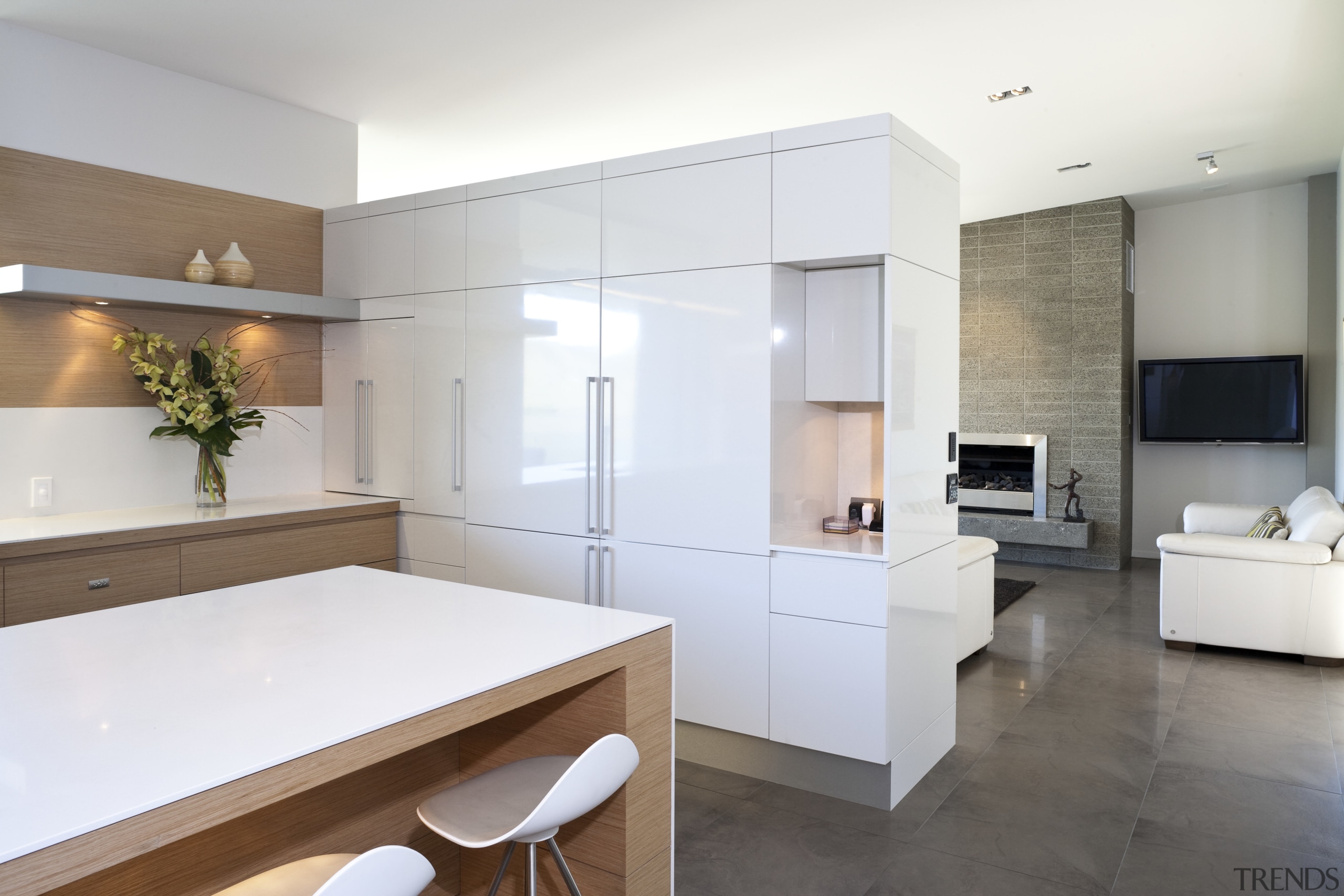 View of kitchen and living area featuring light architecture, countertop, cuisine classique, floor, interior design, kitchen, real estate, room, white, gray