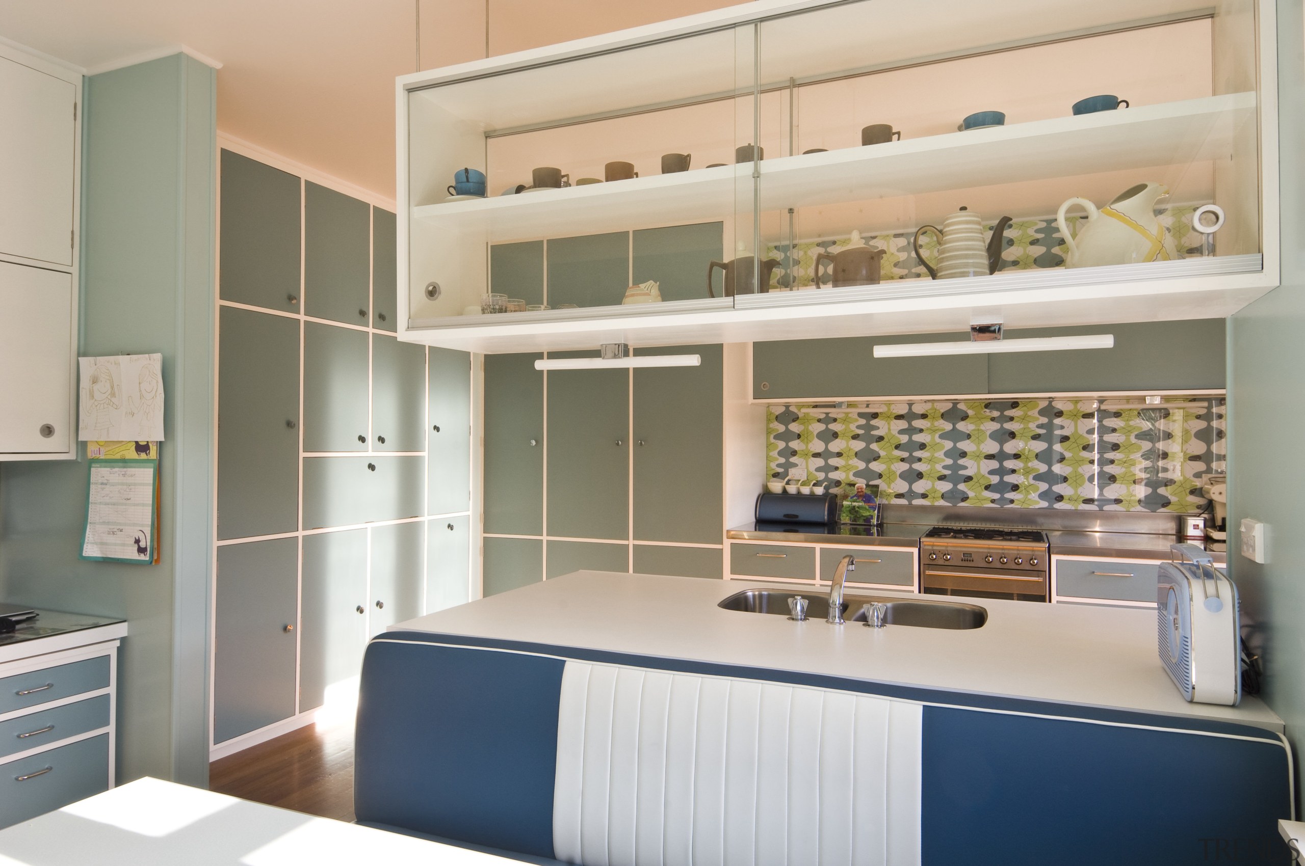 View of a kitchen which features blue cabinetry cabinetry, furniture, interior design, kitchen, product, room, shelving, gray