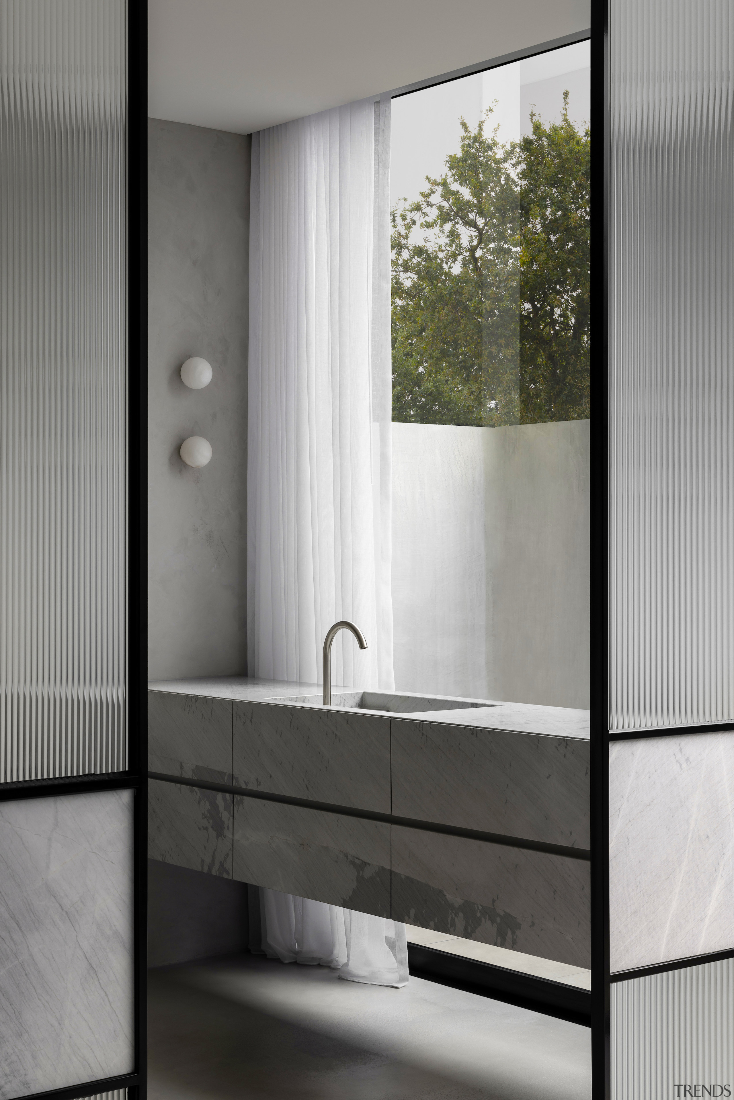 Vanity with understated wall lights. - Refined and 