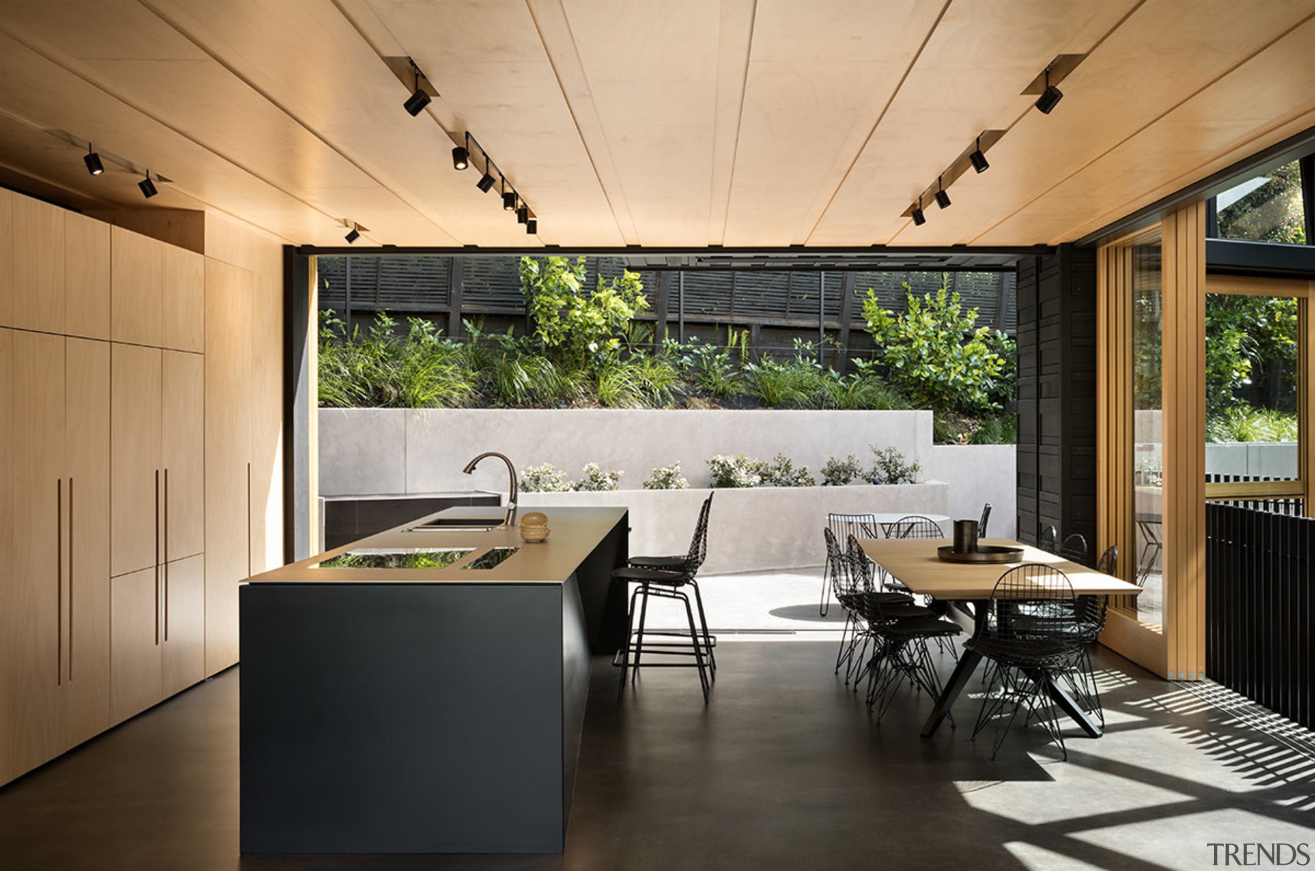 This mid-level kitchen and dining area by Strachan architecture, house, interior design, table, black, Strachan Architects, plywood, stainless steel, Blum, KWC, Tap