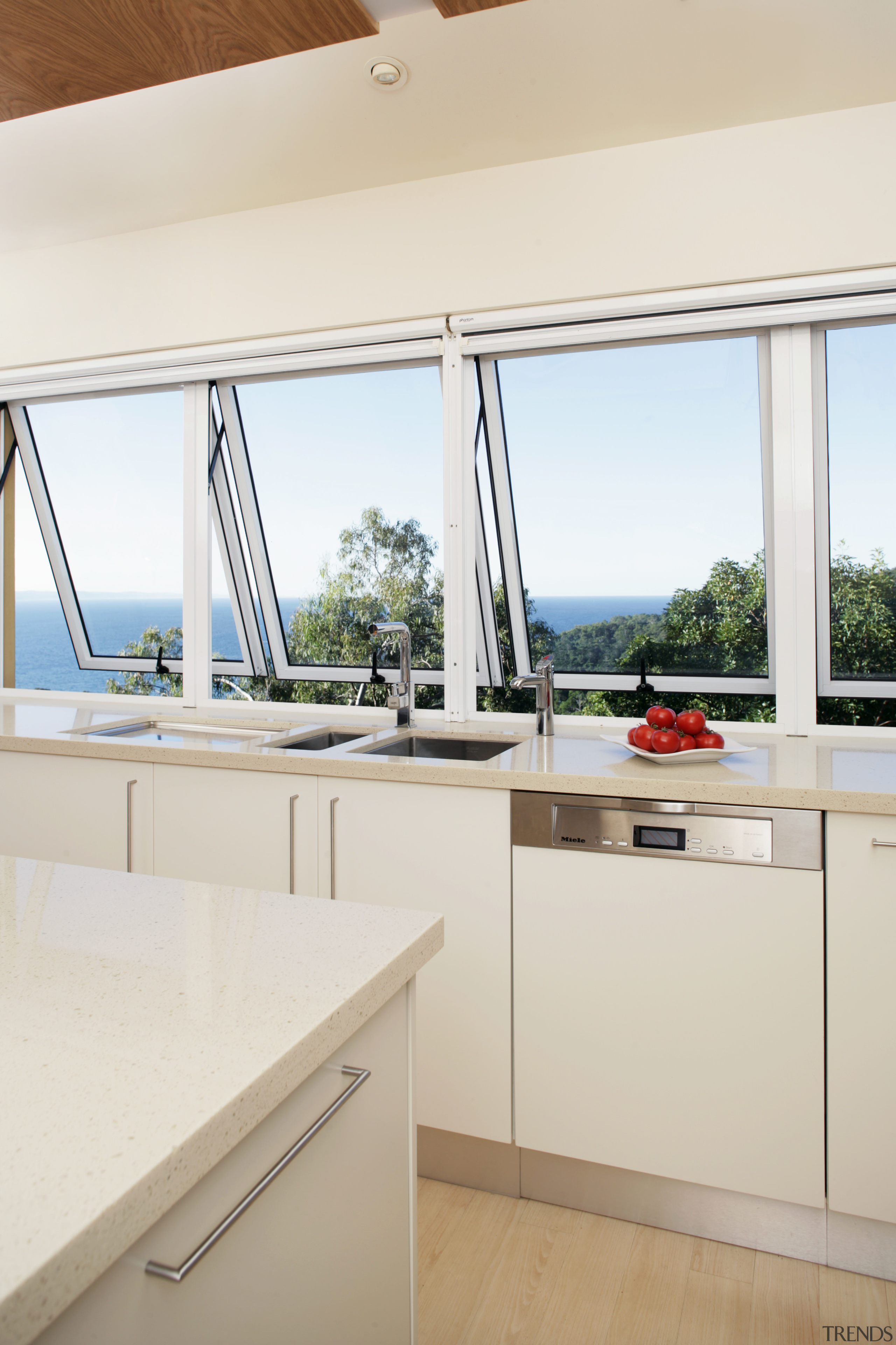 As the windows overlook a national park and architecture, countertop, daylighting, house, interior design, kitchen, real estate, window, white