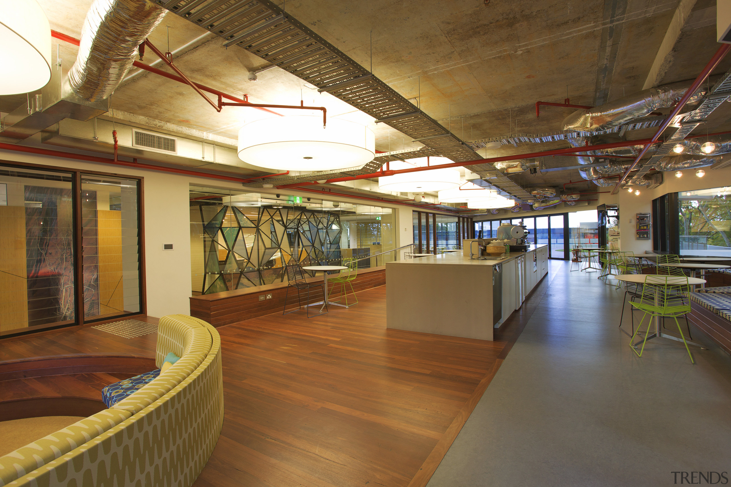 Interior with wooden flooring and exposed red pipes. flooring, interior design, lobby, real estate, brown