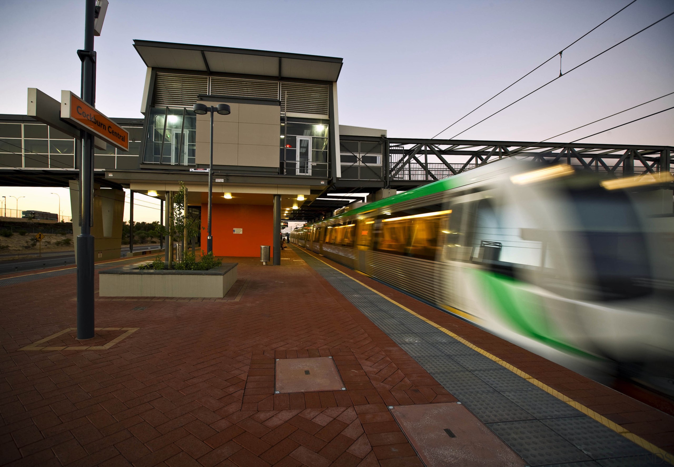 A new bus and train interchange is a architecture, evening, metropolitan area, public transport, rail transport, rapid transit, residential area, sky, track, train, train station, transport, urban area, vehicle