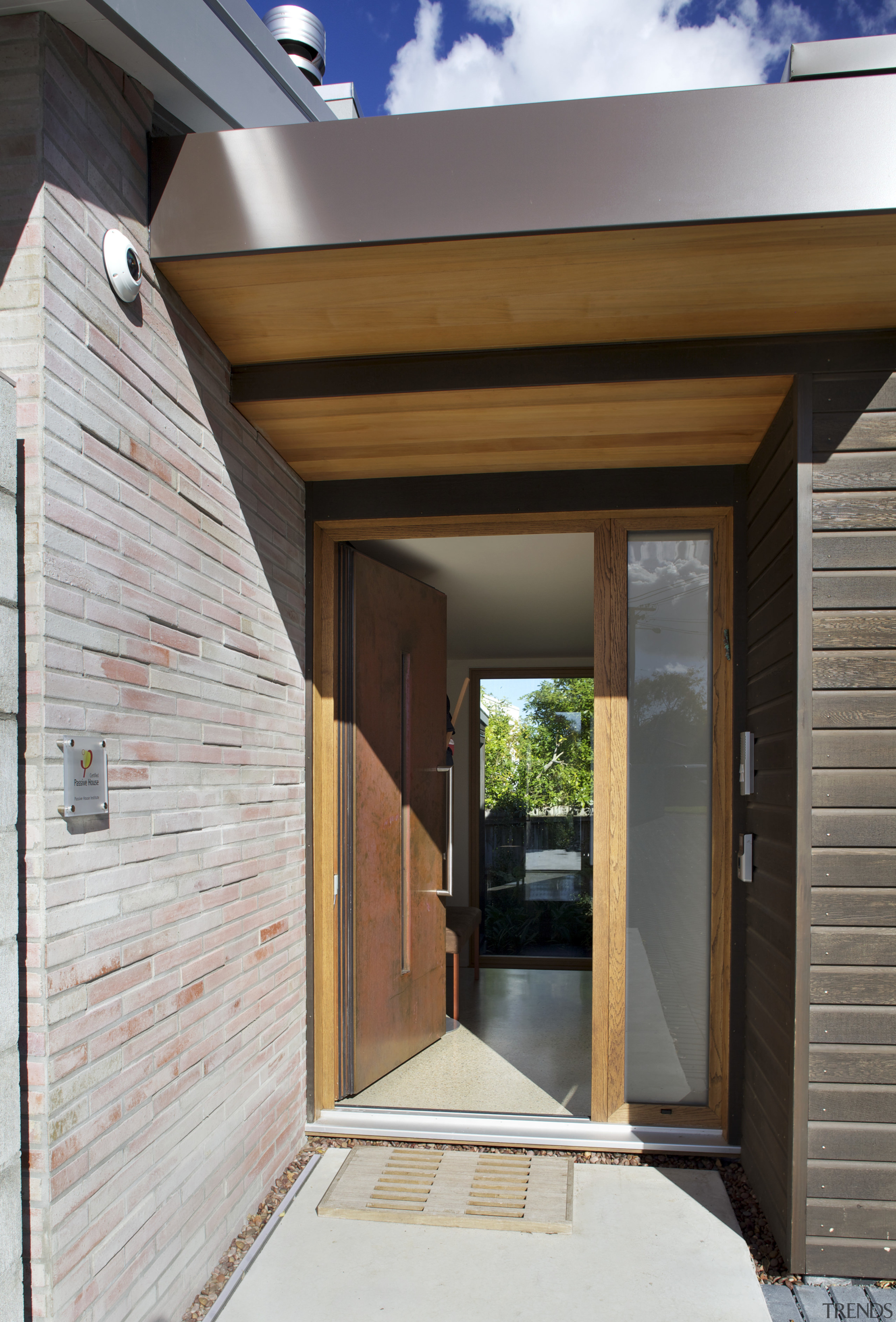 North-facing glazing and solar panels on the roof architecture, daylighting, door, facade, home, house, real estate, siding, window, wood, wood stain, gray