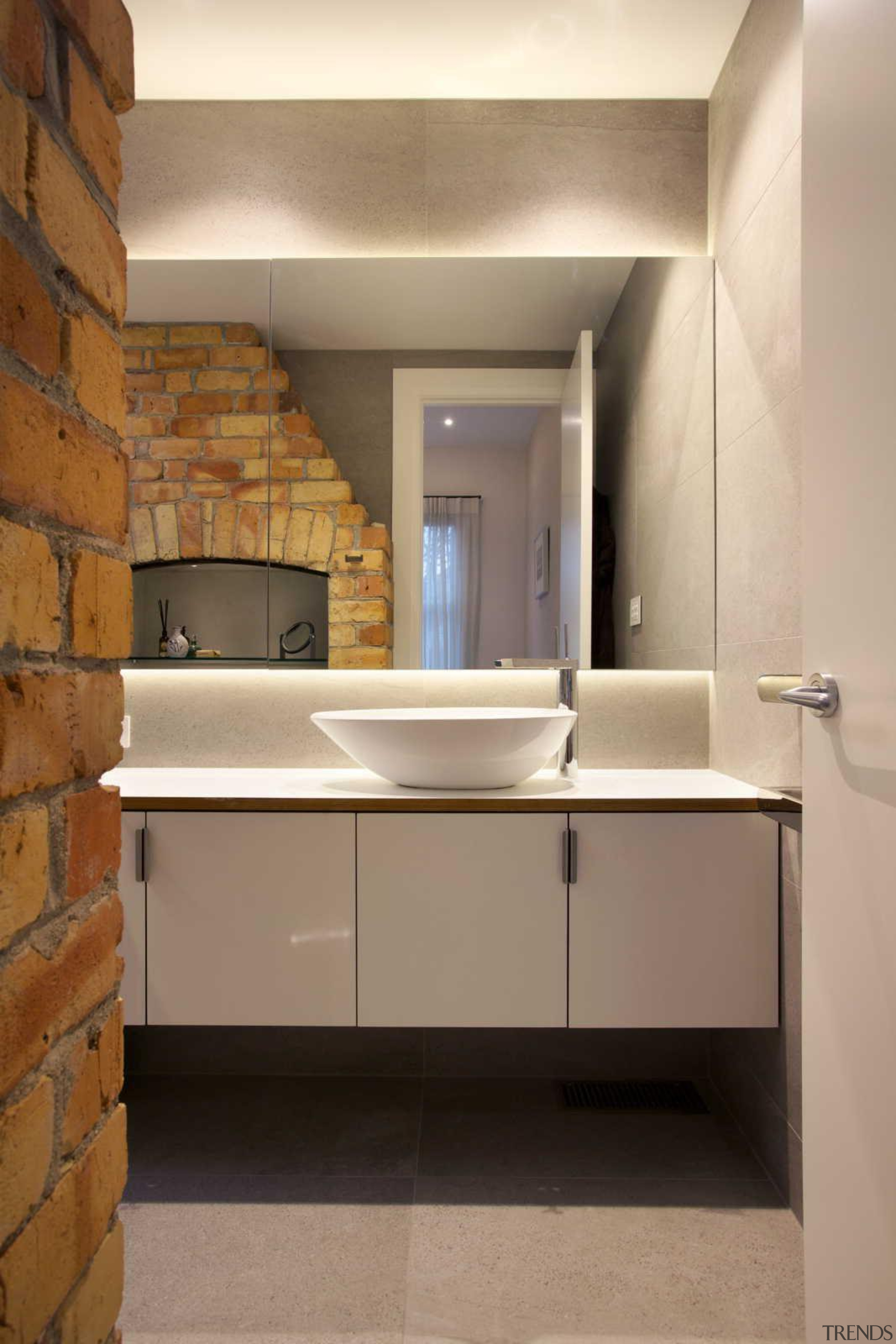 Generous cabinetry for storage in the new bathroom. bathroom, bathroom accessory, bathroom cabinet, cabinetry, countertop, floor, interior design, room, sink, tile, brown, orange