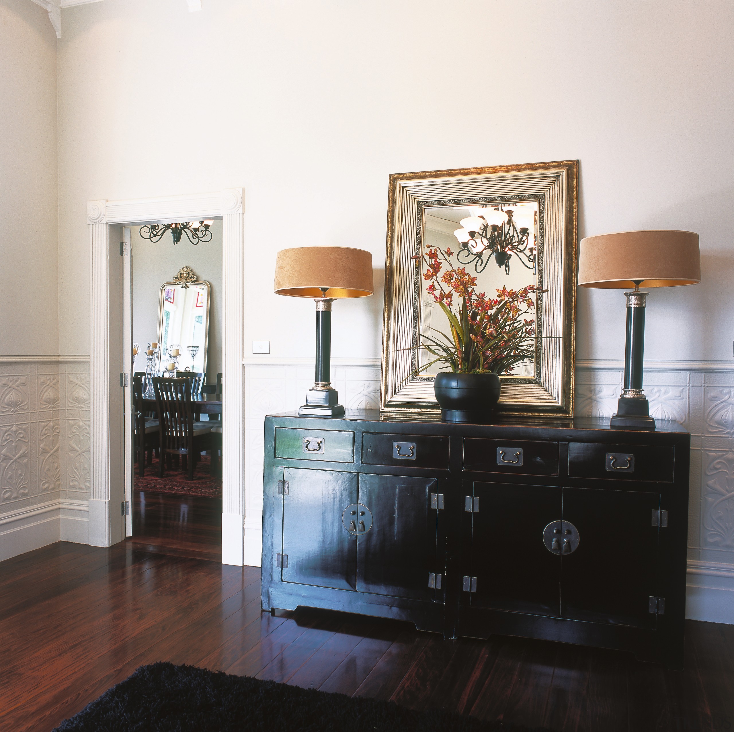 A view of a wooden chest, wooden flooring, chest of drawers, drawer, furniture, home, interior design, living room, room, sideboard, table, white, black