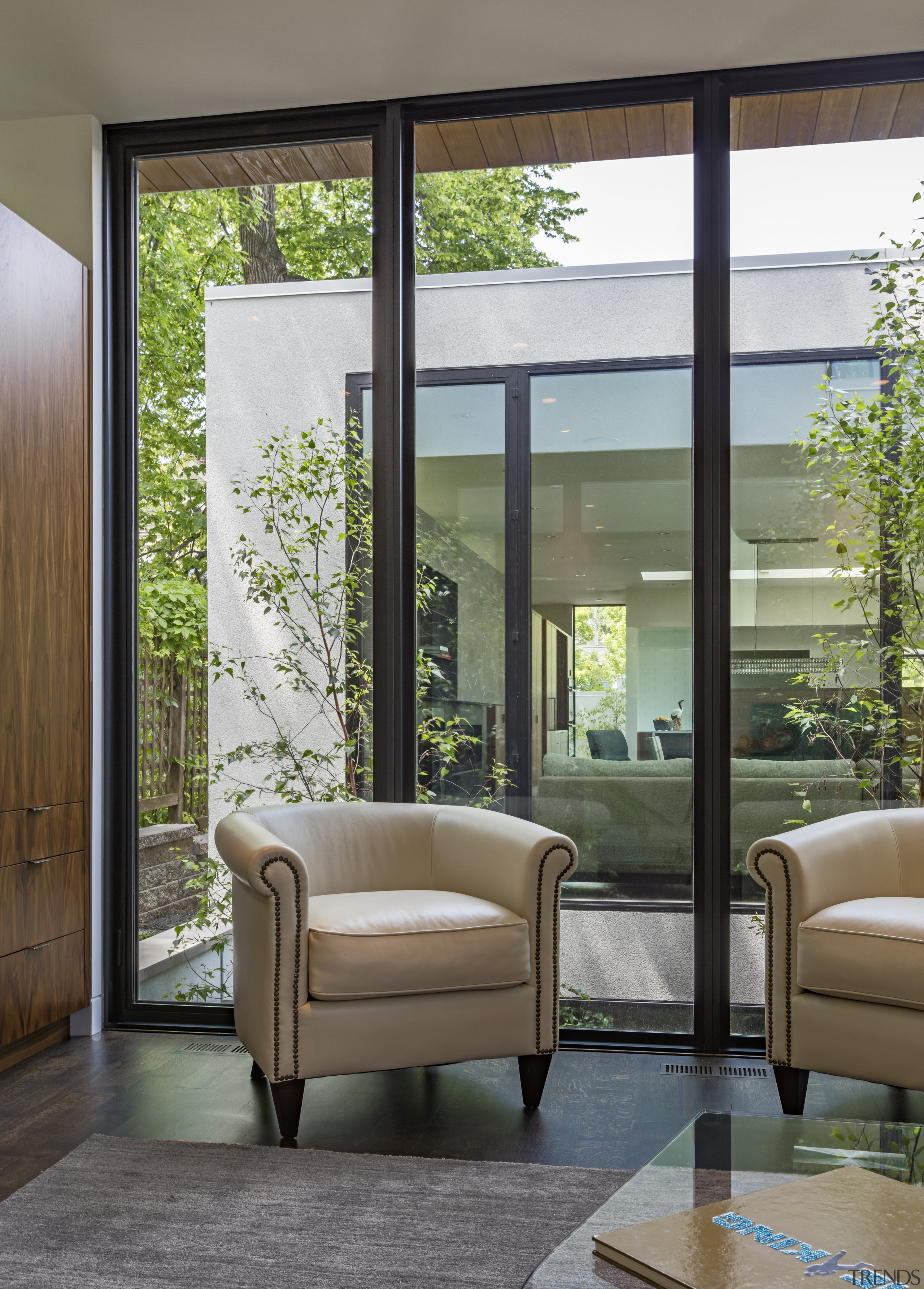 ​​​​​​​Light wells planted with birch trees sit between architecture, door, furniture, interior design, living room, window, window covering, gray, Peterssen Keller Architects