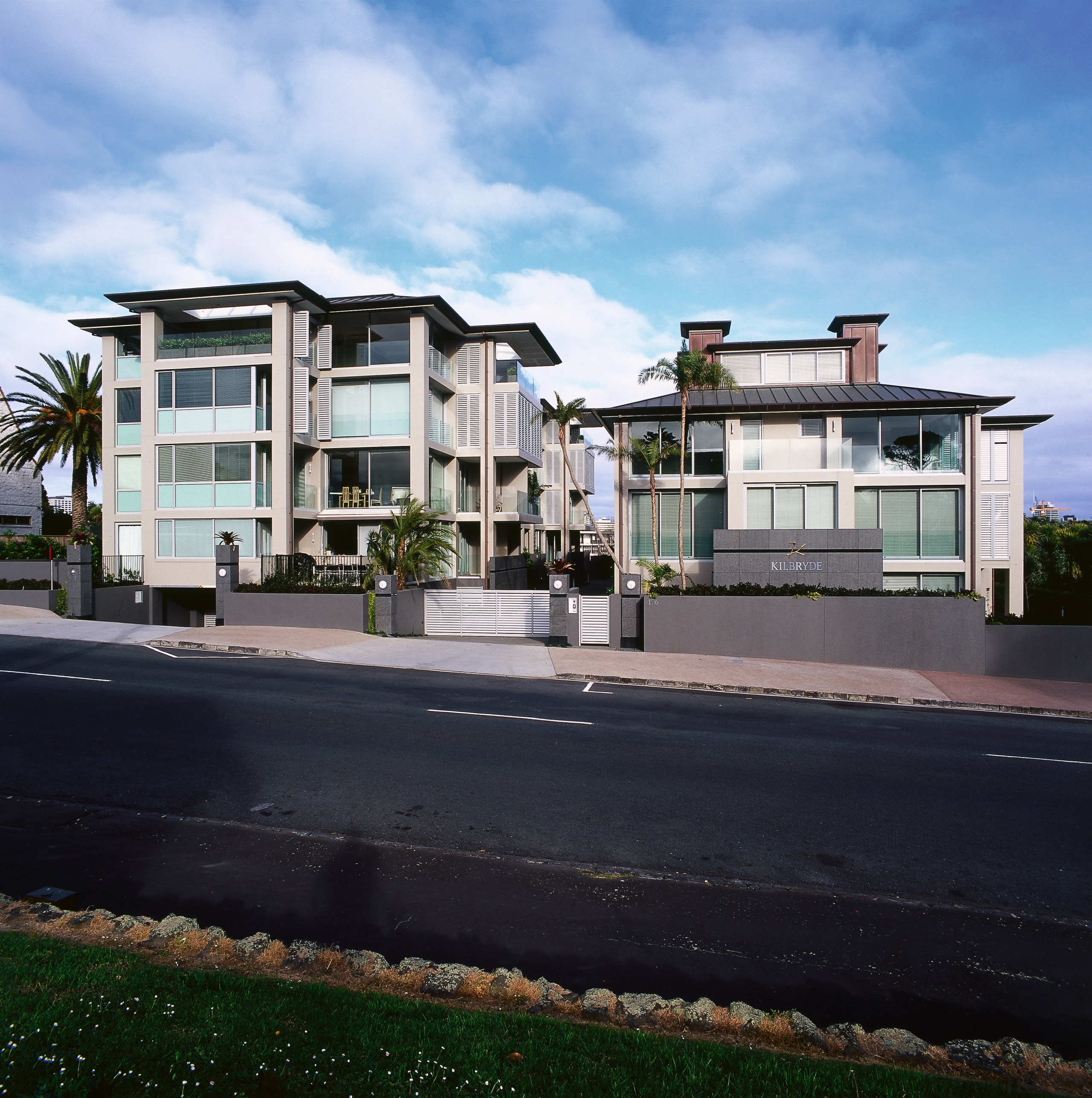 An exterior view of the apartments. - An apartment, architecture, building, condominium, estate, facade, home, house, mixed use, neighbourhood, property, real estate, residential area, sky, suburb, window, black