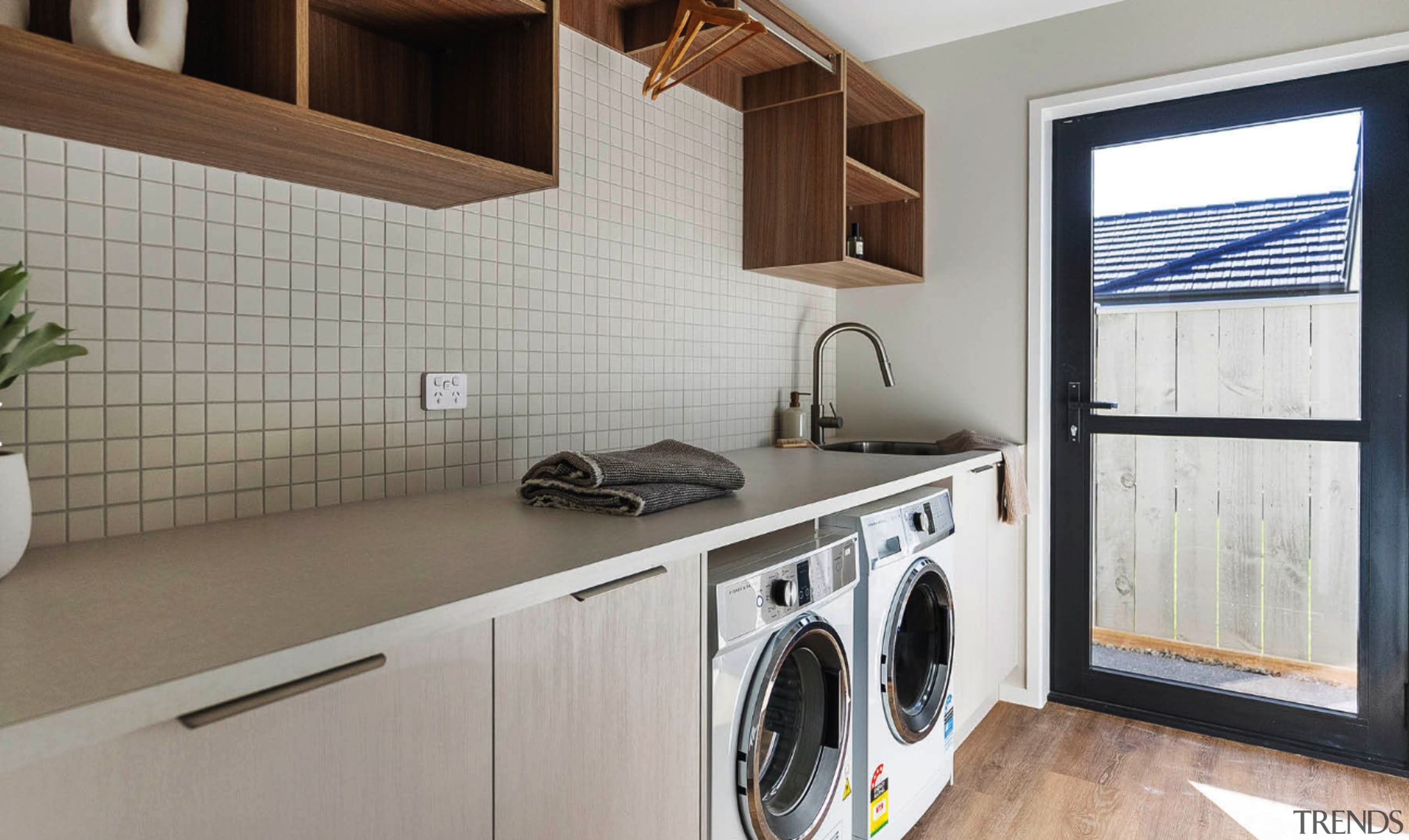 A mosaic tile splashback, timber cabinetry and a 