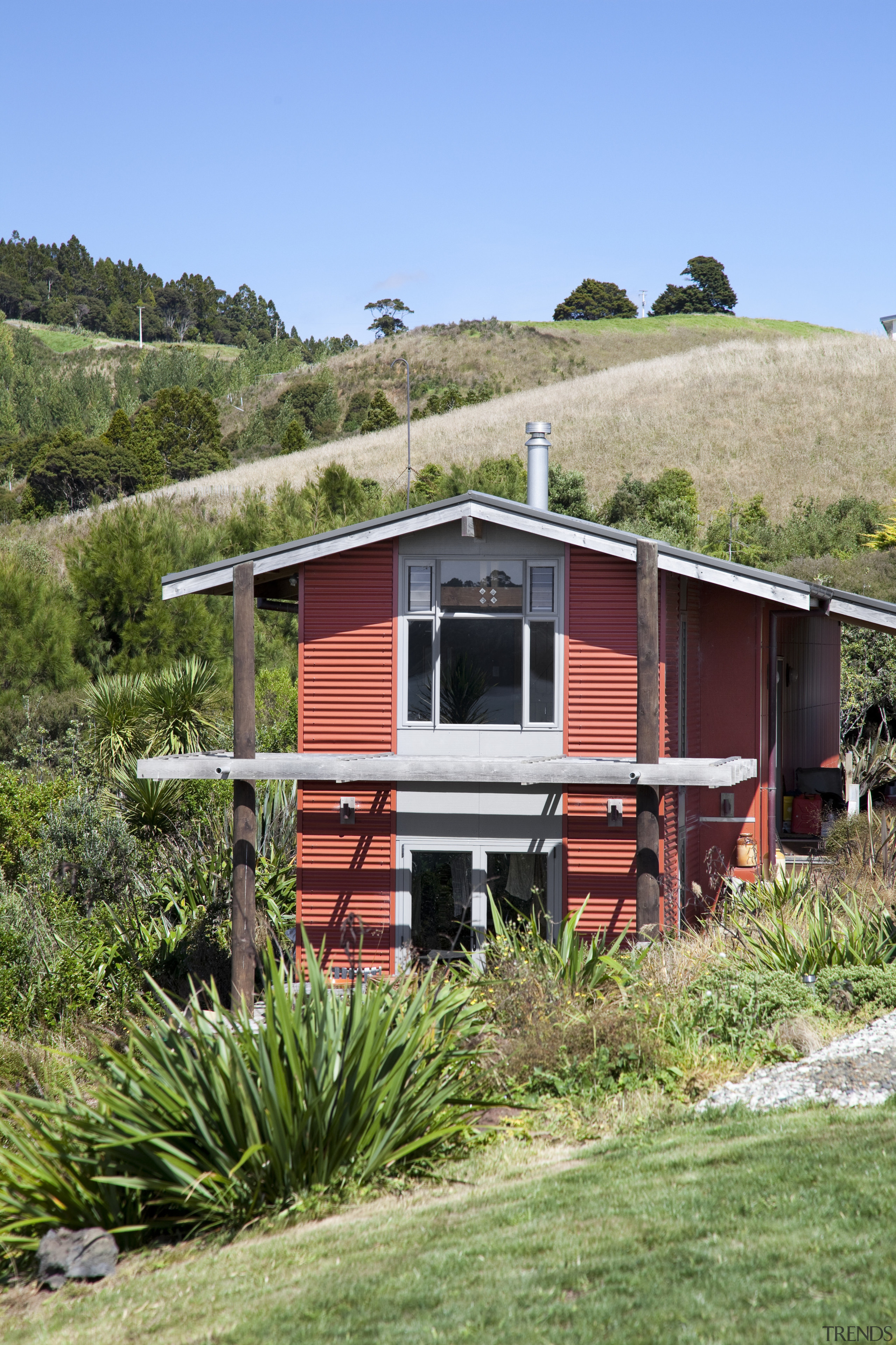 Exterior view of red house surrounded by trees cottage, home, house, hut, landscape, plant, railroad car, real estate, rolling stock, rural area, shack, shed