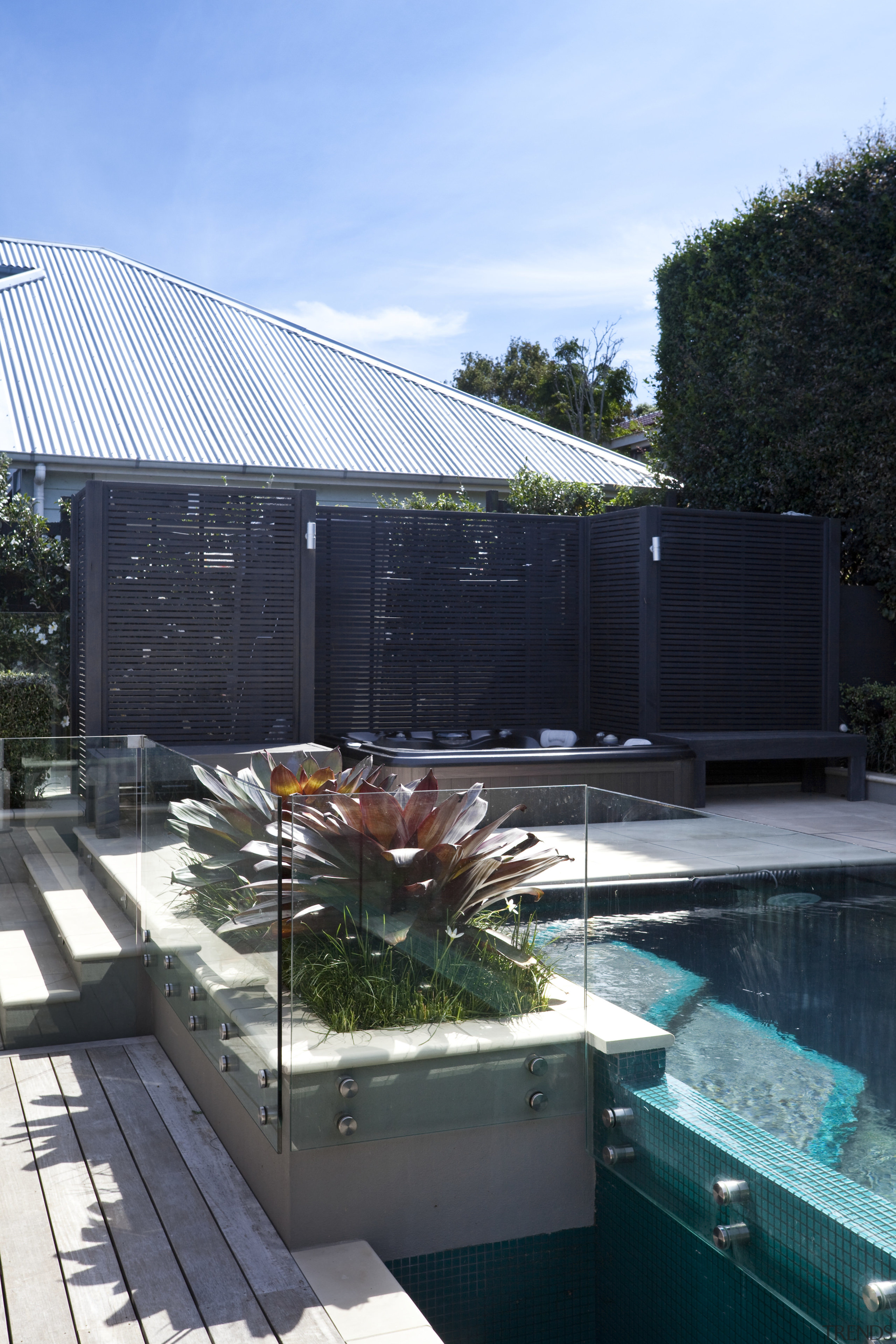 The rear yard of this home has been architecture, daylighting, home, house, reflection, roof, swimming pool, water, black, teal