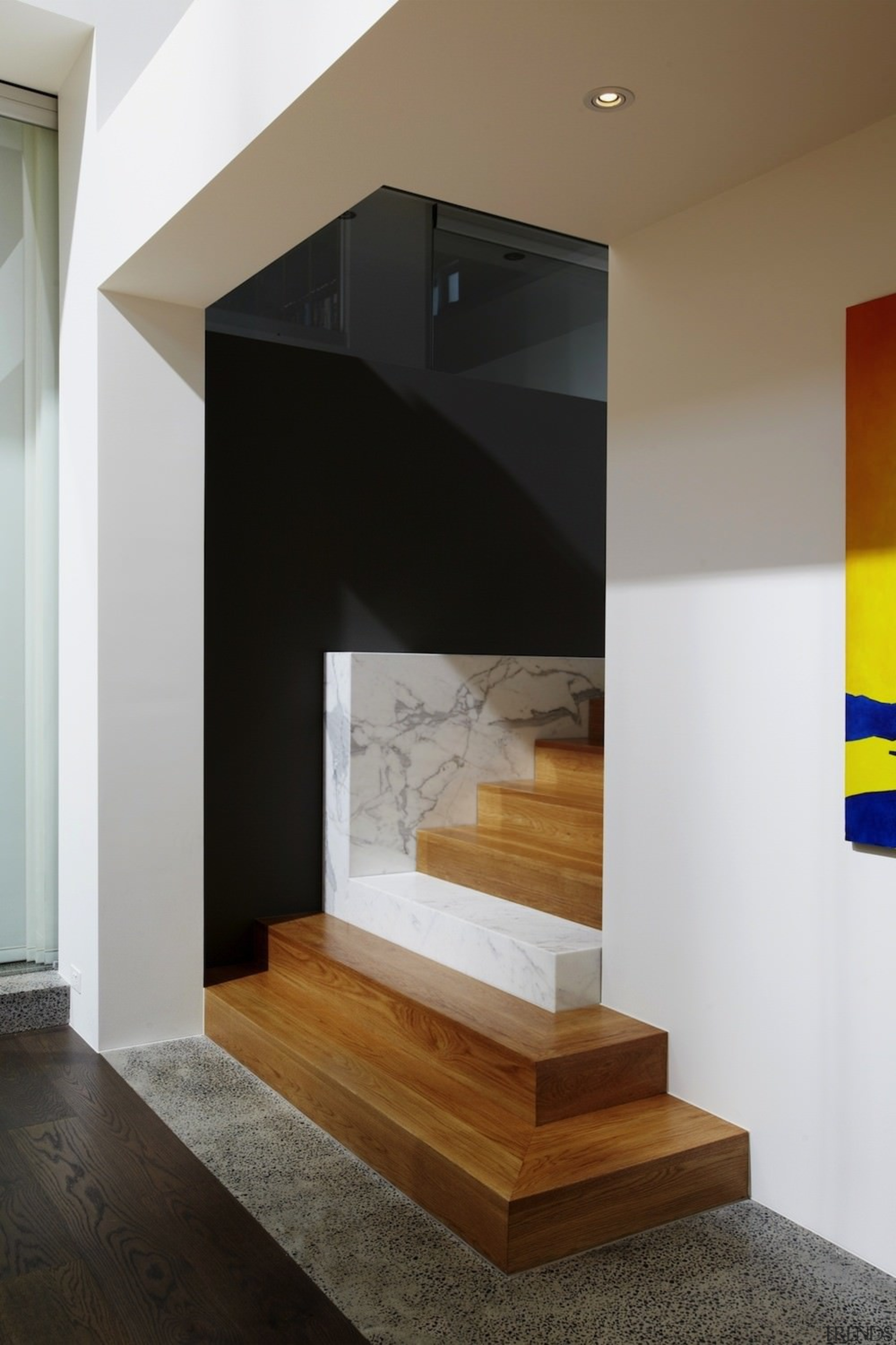 A lone marble step intersects the wood in architecture, fireplace, floor, furniture, hearth, house, interior design, stairs, wall, brown, black