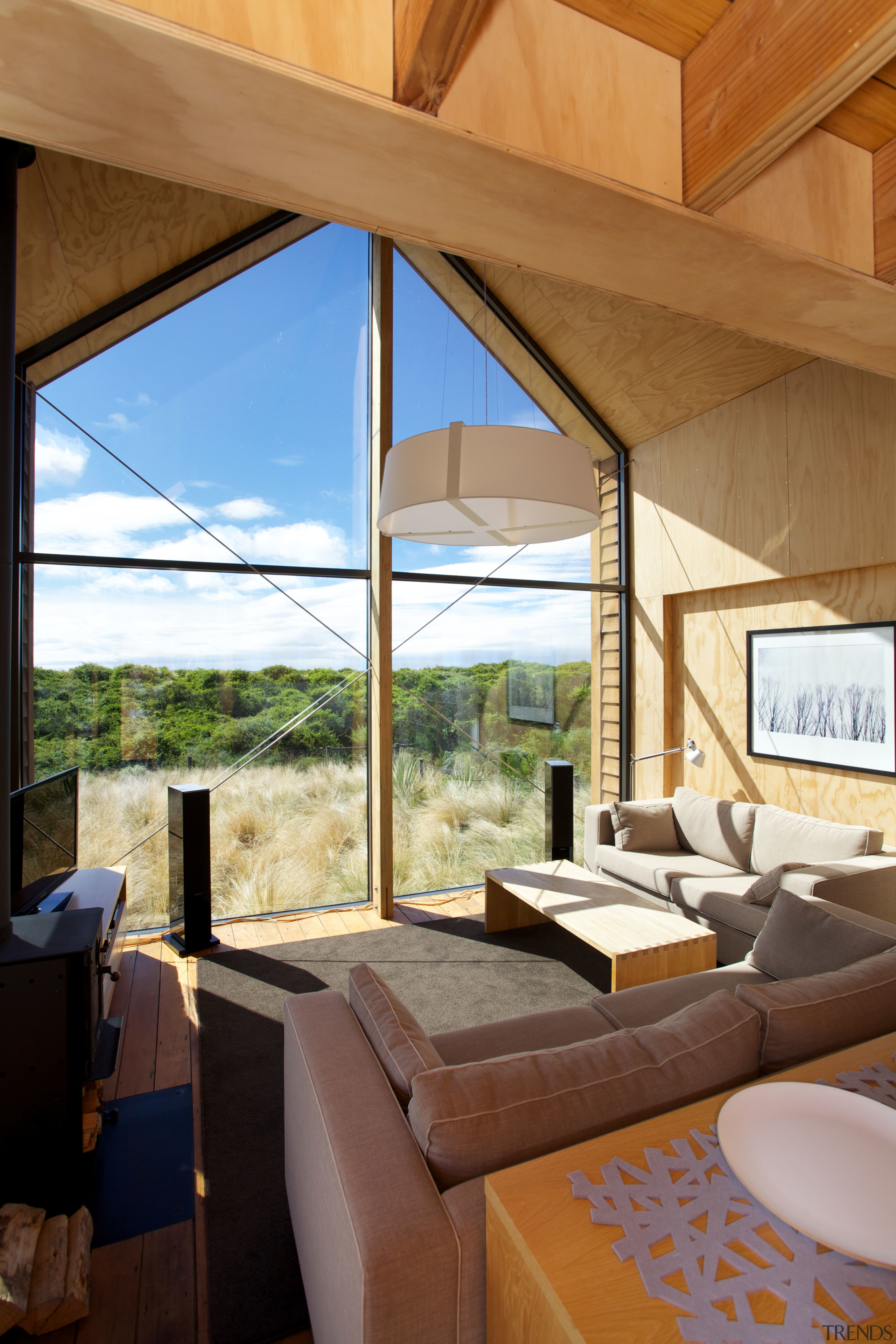 A recessed area in the plywood interior of architecture, ceiling, daylighting, house, interior design, living room, real estate, window, brown