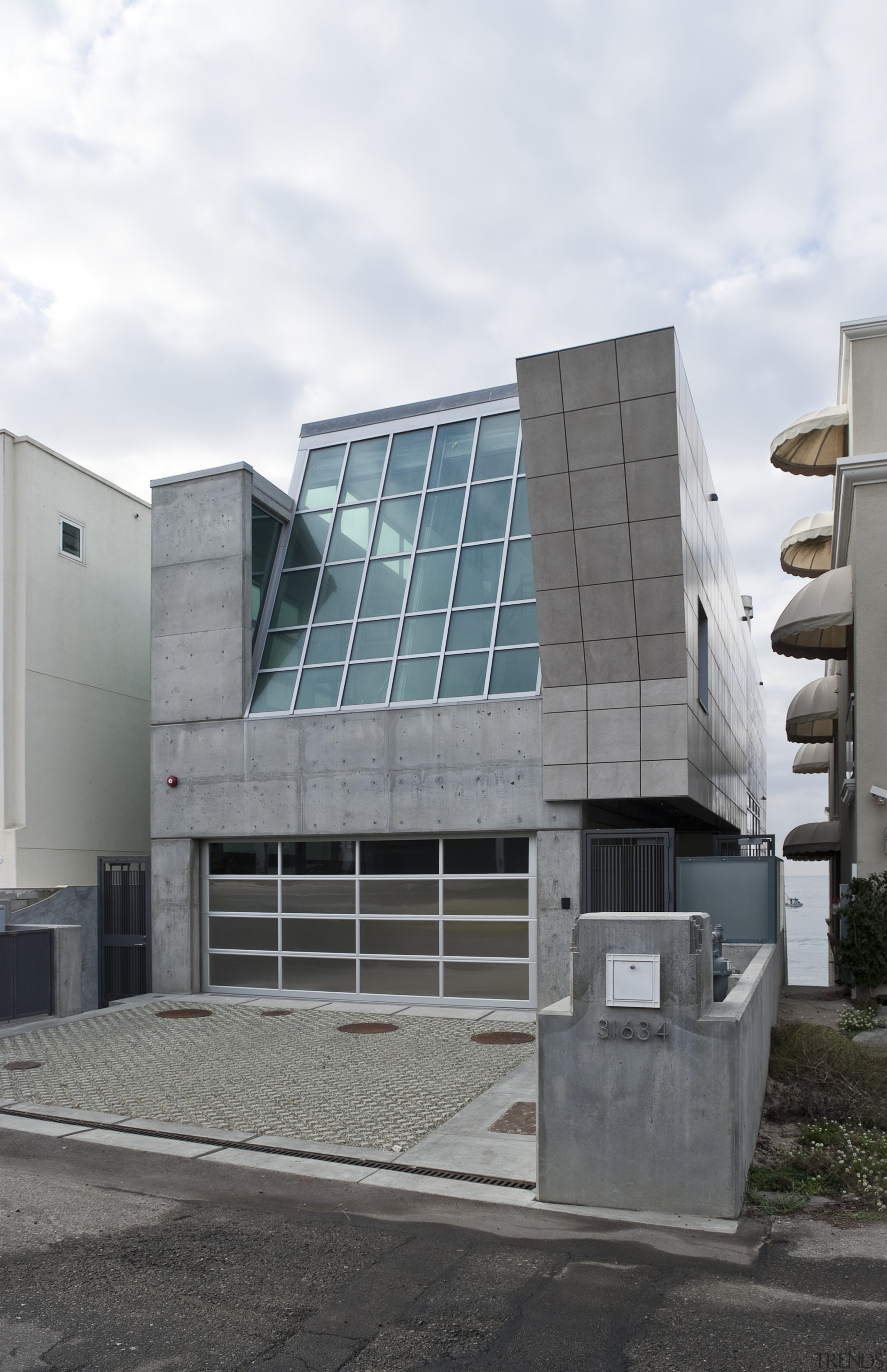 View of homes exterior featuring tile siding, lead architecture, building, commercial building, condominium, corporate headquarters, facade, house, residential area, gray, white